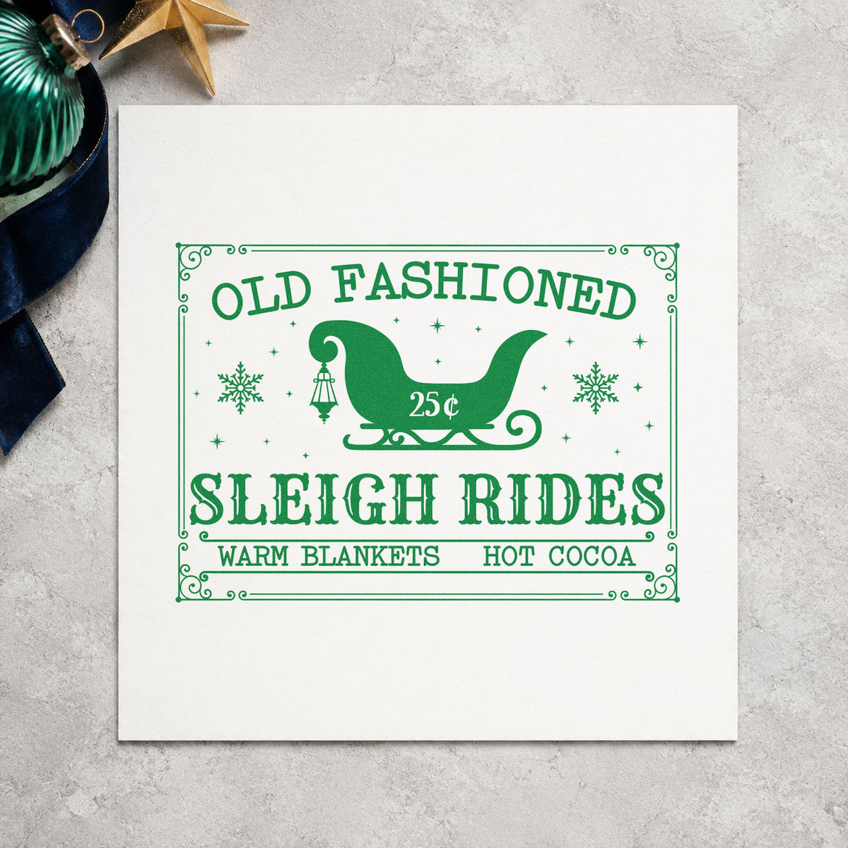 Old Fashioned Sleigh Rides craft stamp imprint in green ink on a handmade project, one idea being blanket bundle tags.