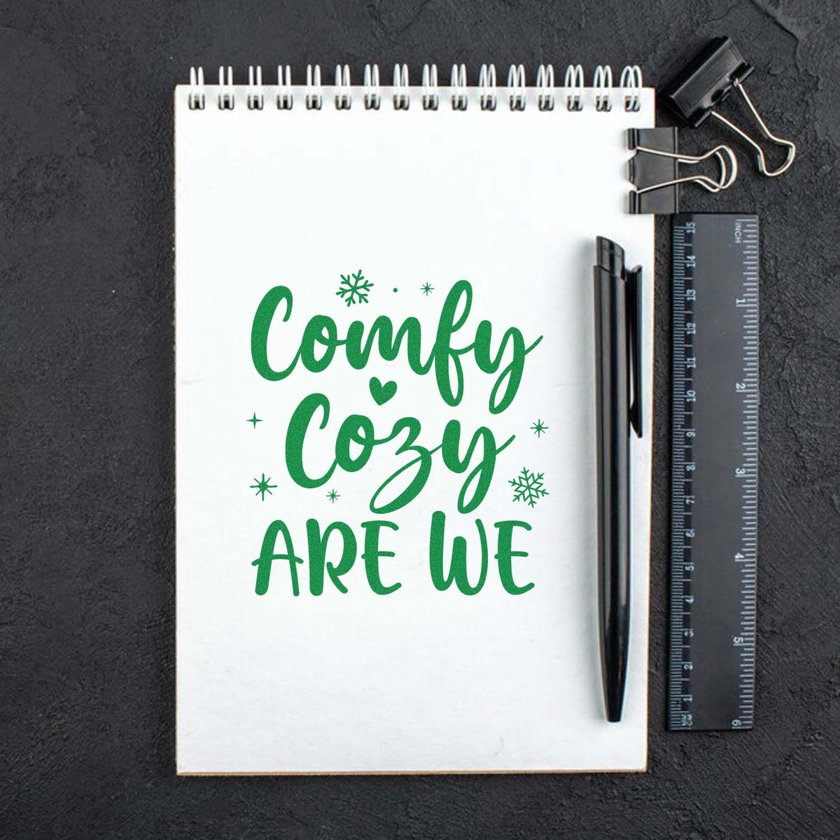 Comfy Cozy Are We custom rubber stamp design on notebook mockup, perfect for winter crafts, journaling, and handmade gifts.