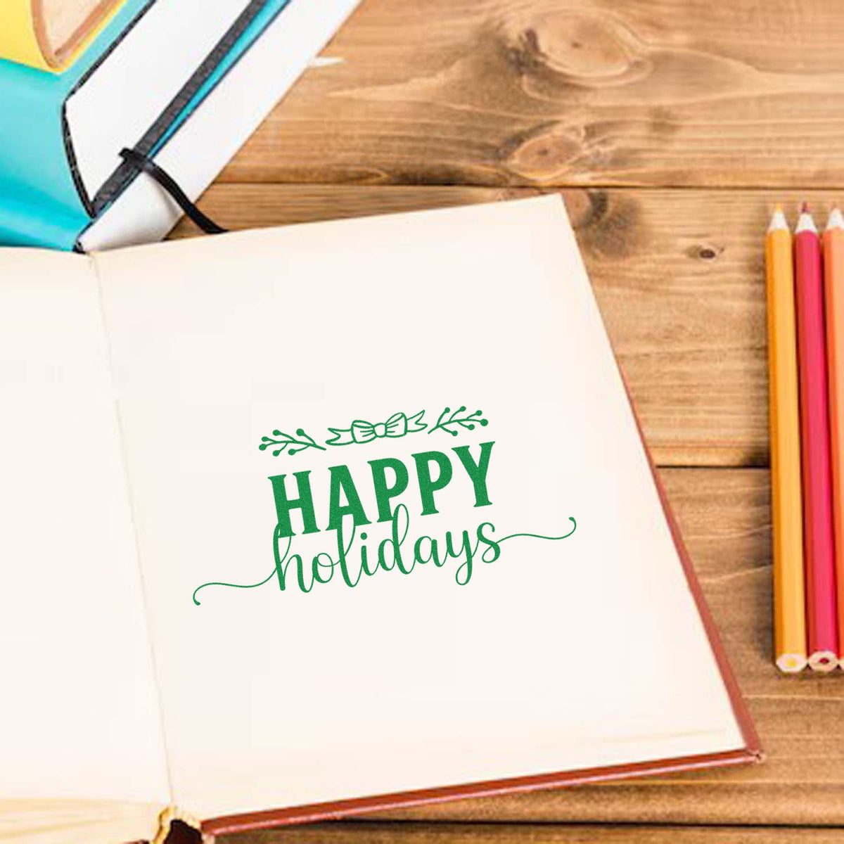 Happy Holidays rubber stamp design on an open notebook, ideal for festive card making, journaling, and holiday crafts.