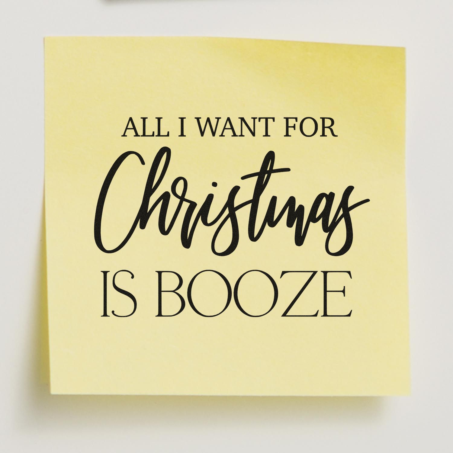 Christmas rubber stamp design reading All I Want for Christmas Is Booze in bold black lettering.