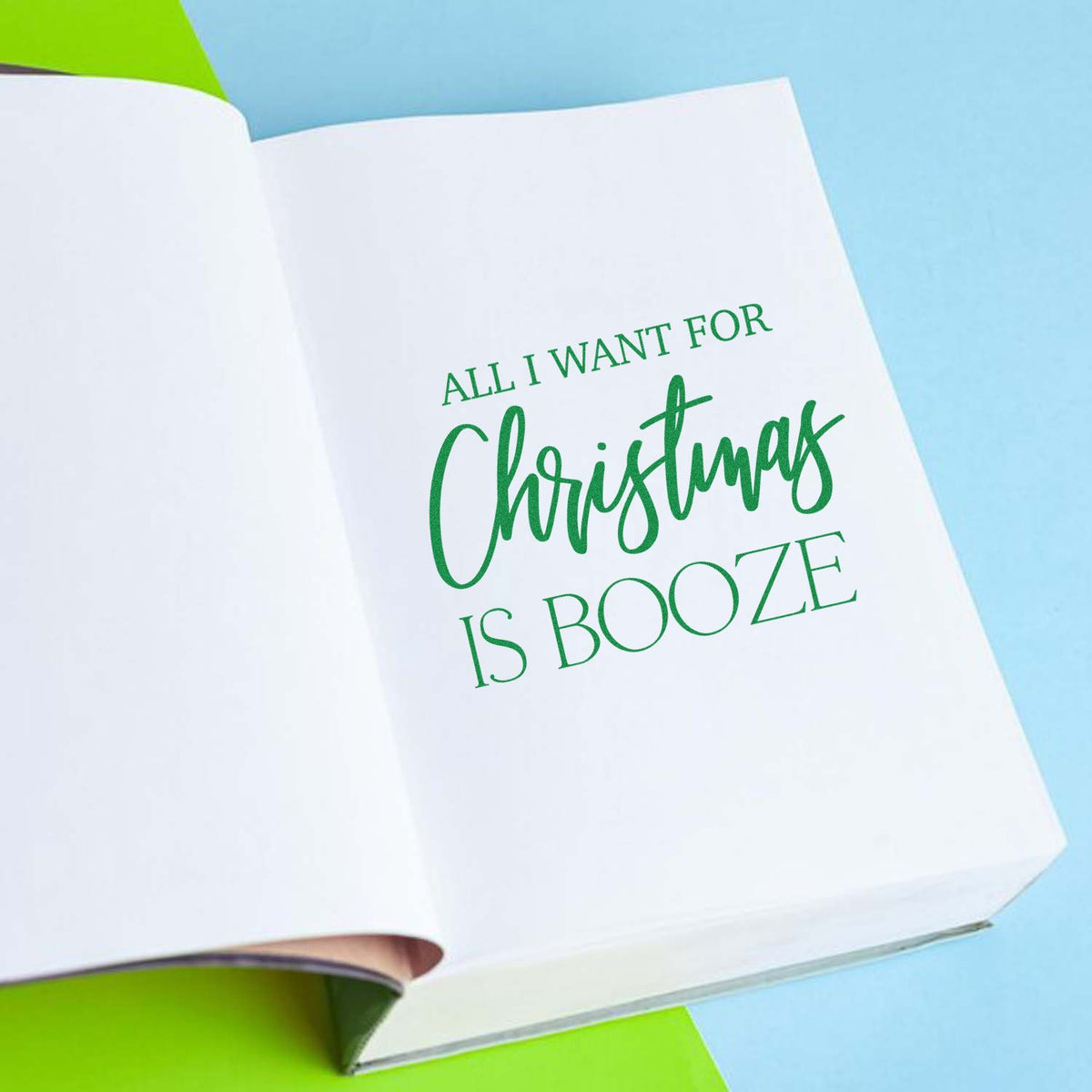 All I Want Christmas Booze rubber stamp shown in green ink, stamped for projects such as bar cart album page.