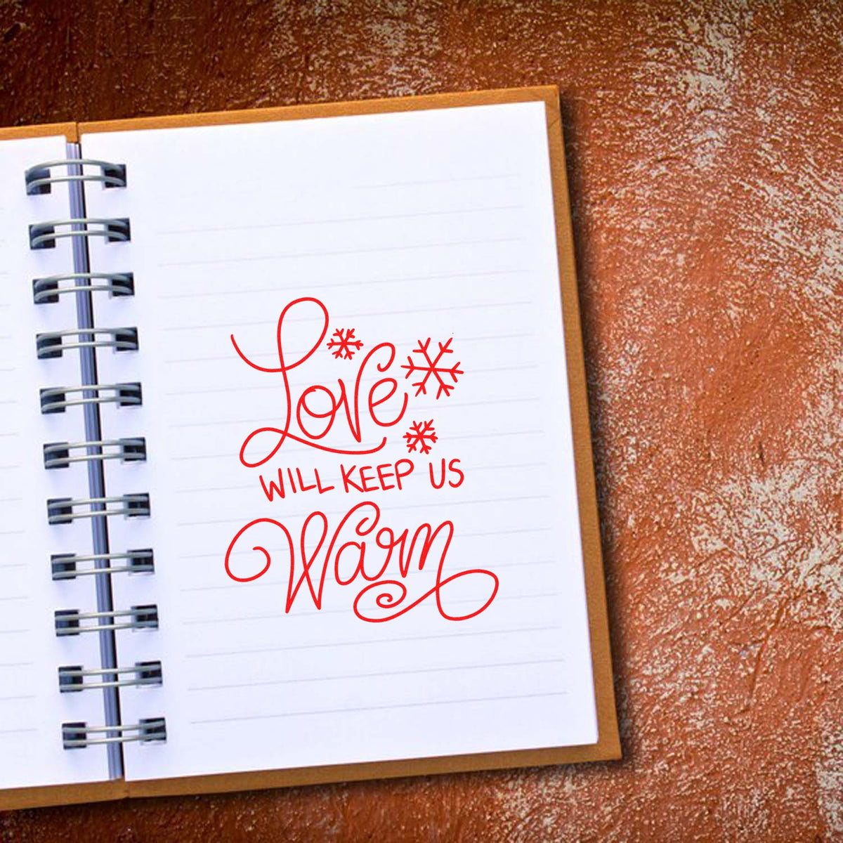 Love Will Keep Us Warm rubber stamp on a notebook page, perfect for Christmas cards and winter crafts.