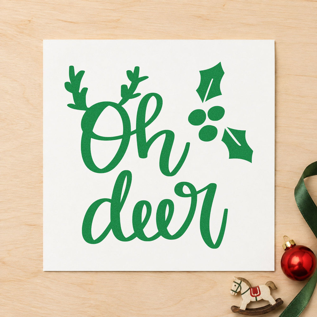 Oh Deer Holly Antlers craft stamp imprint in green ink on a handmade project, one idea being berry bundle tags.