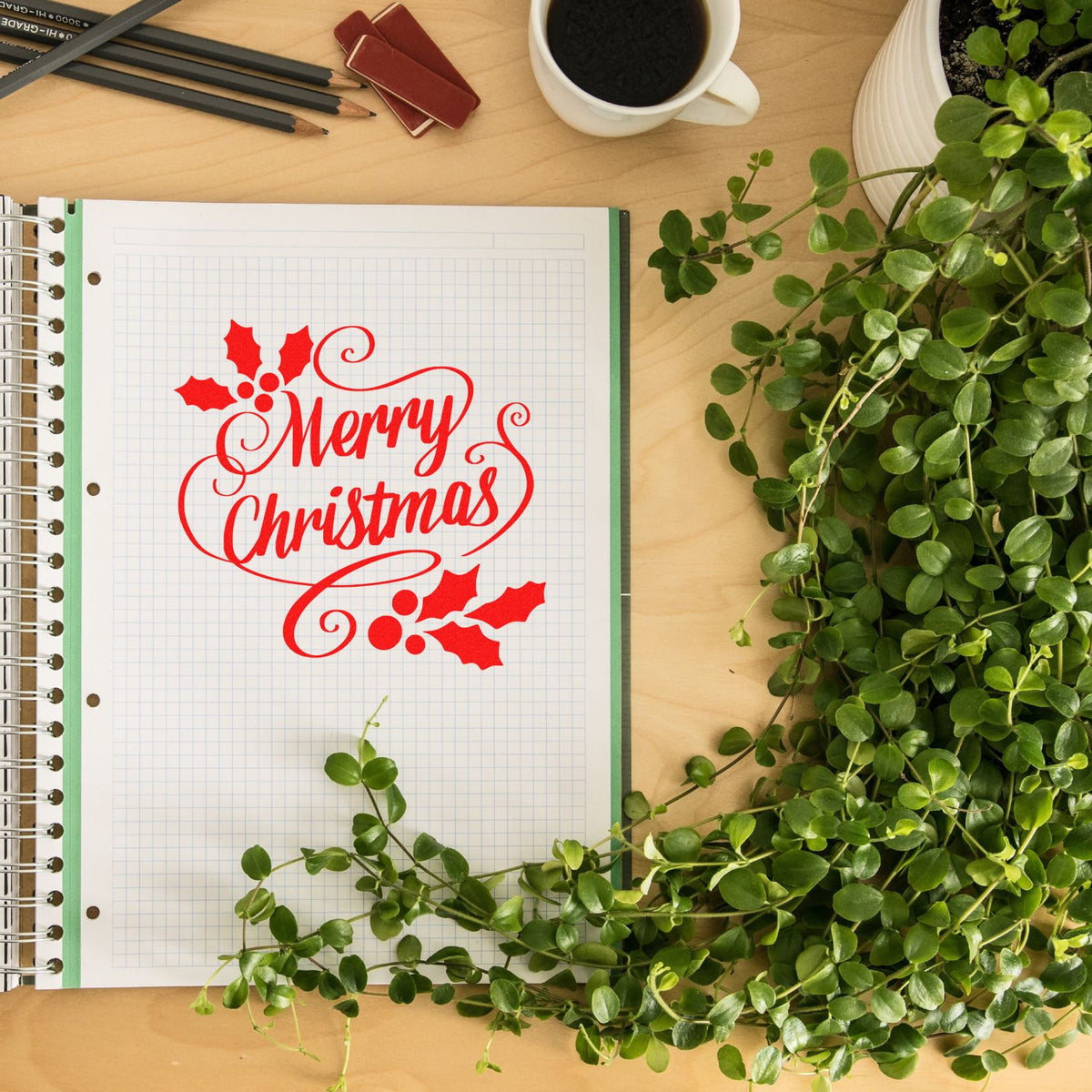 Merry Christmas rubber stamp design in a notebook, perfect for holiday card making, scrapbooking, and festive craft projects.
