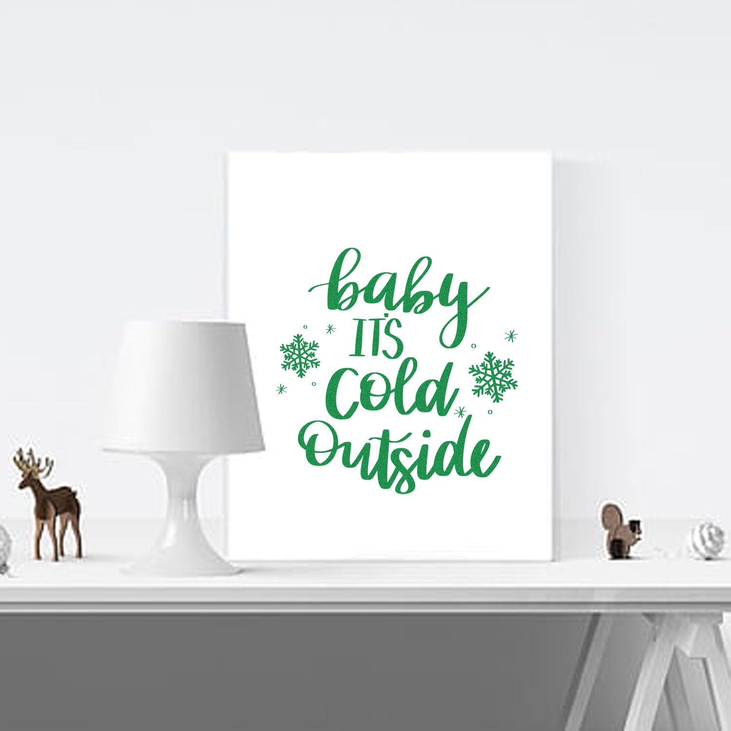 Winter rubber stamp design with green Baby Its Cold Outside lettering and snowflakes for holiday dcor.