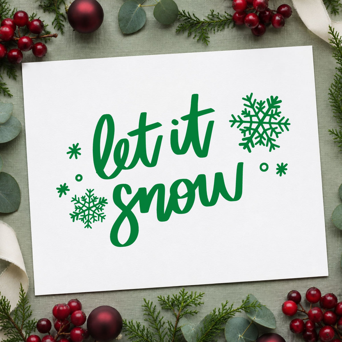 Let It Snow Script Snowflakes craft stamp imprint in green ink on a handmade project, one idea being everyday gift tags.