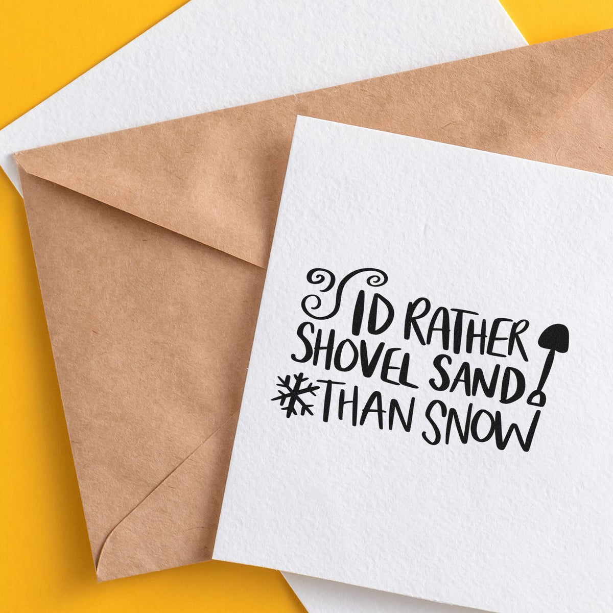 Slim Pre-Inked I'd Rather Shovel Sand Than Snow Stamp imprint stamped in black ink. The phrase "I'd rather shovel sand than snow" includes a shovel and snowflake.