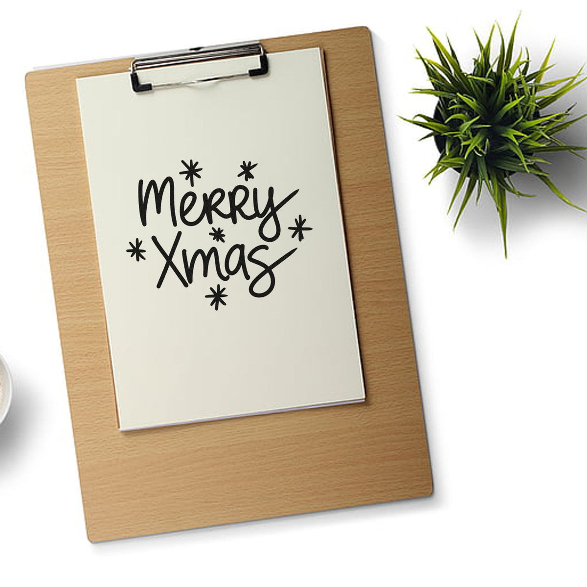 Merry Xmas rubber stamp design on clipboard, festive hand-lettered Christmas stamp for cards, packaging, and holiday crafts.