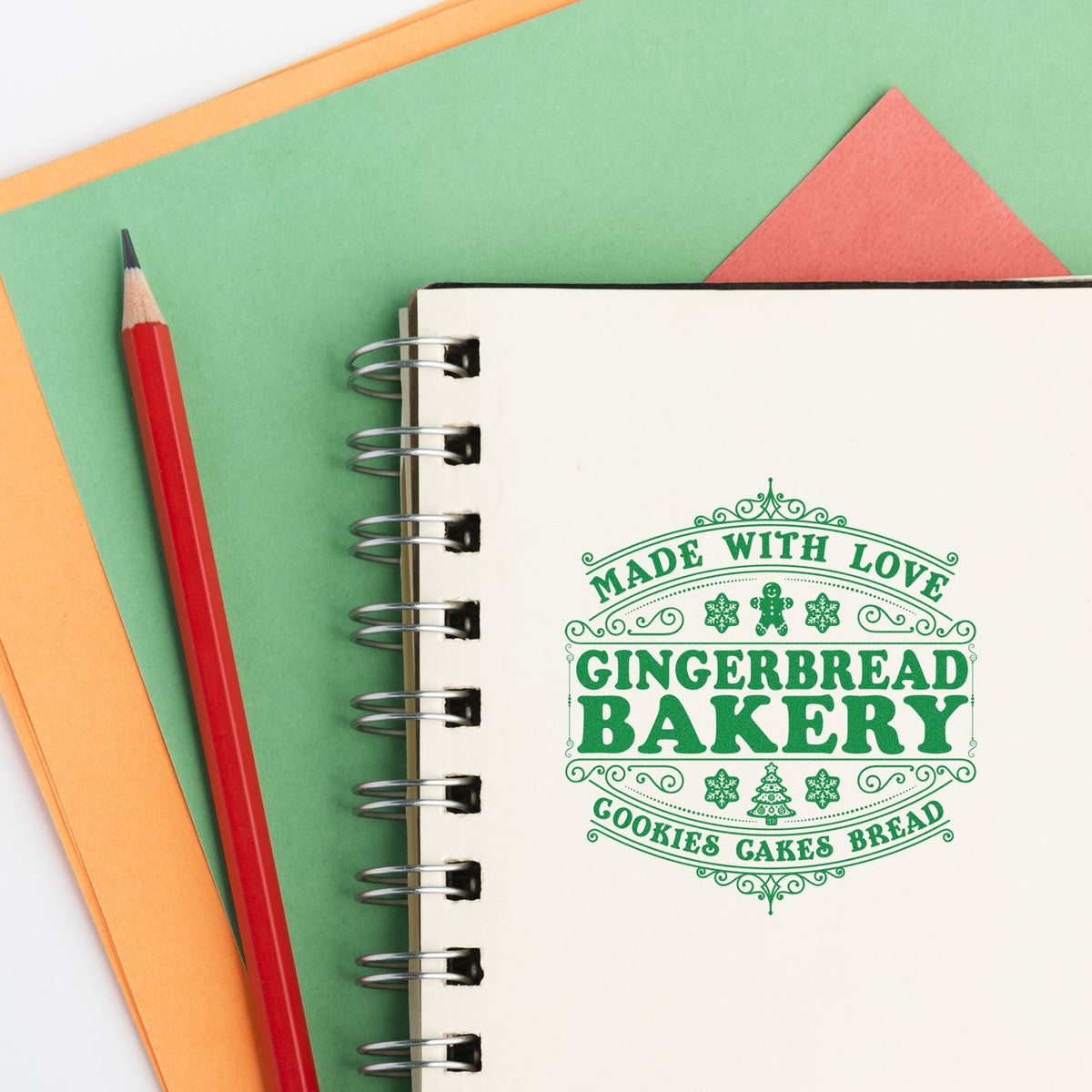 Gingerbread bakery rubber stamp design in a notebook, featuring Made with Love and cookies, cakes, bread lettering.