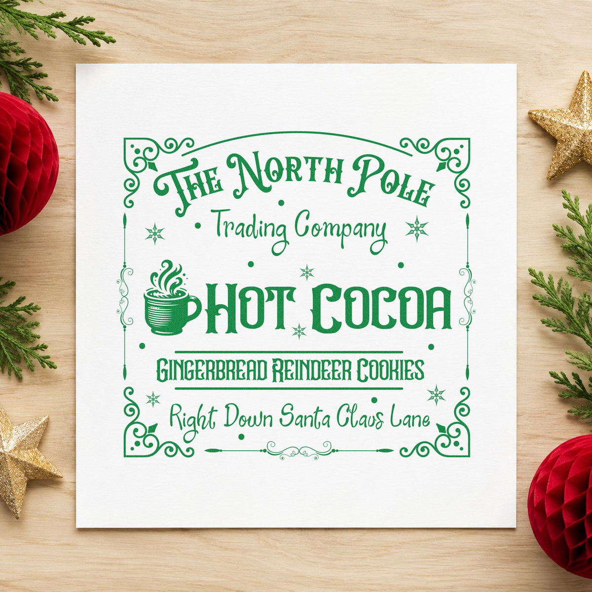 North Pole Trading Hot Cocoa craft stamp imprinted in green ink on paper, a design suited to framed menu board.