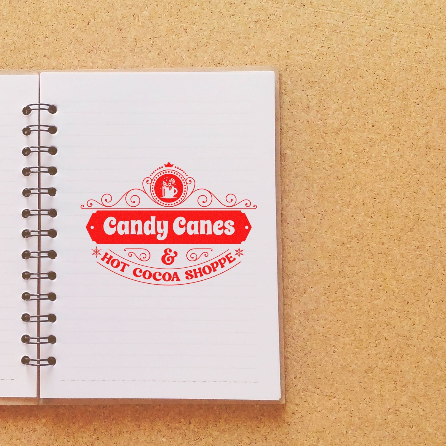 Candy Canes & Hot Cocoa Shoppe custom rubber stamp for festive holiday branding, shown stamped on a notebook page.