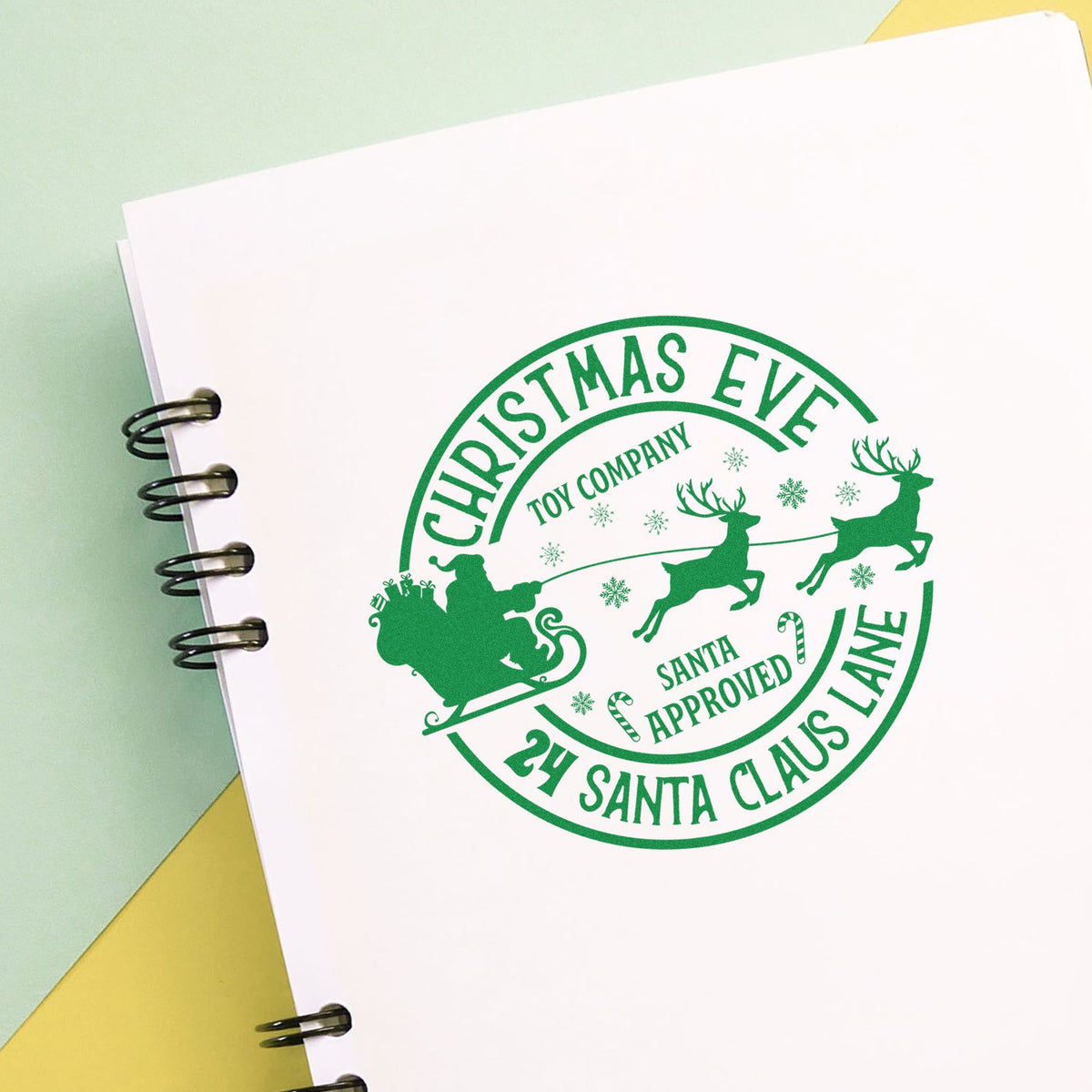 Christmas Eve Toy Company rubber stamp shown in green ink, stamped for projects such as workshop album page.