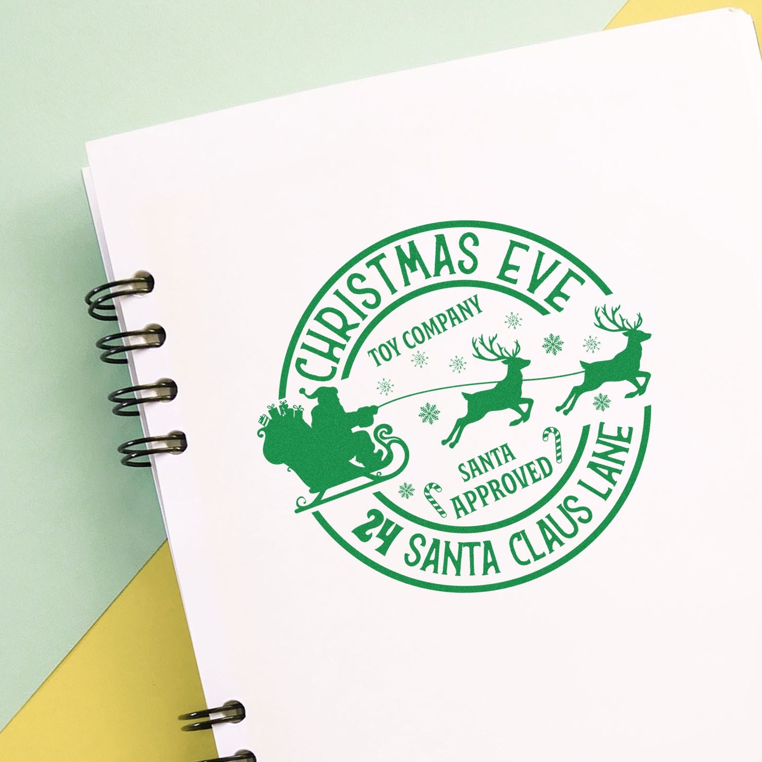 Custom Christmas Eve rubber stamp design with Santa sleigh, reindeer, and holiday toy company branding.