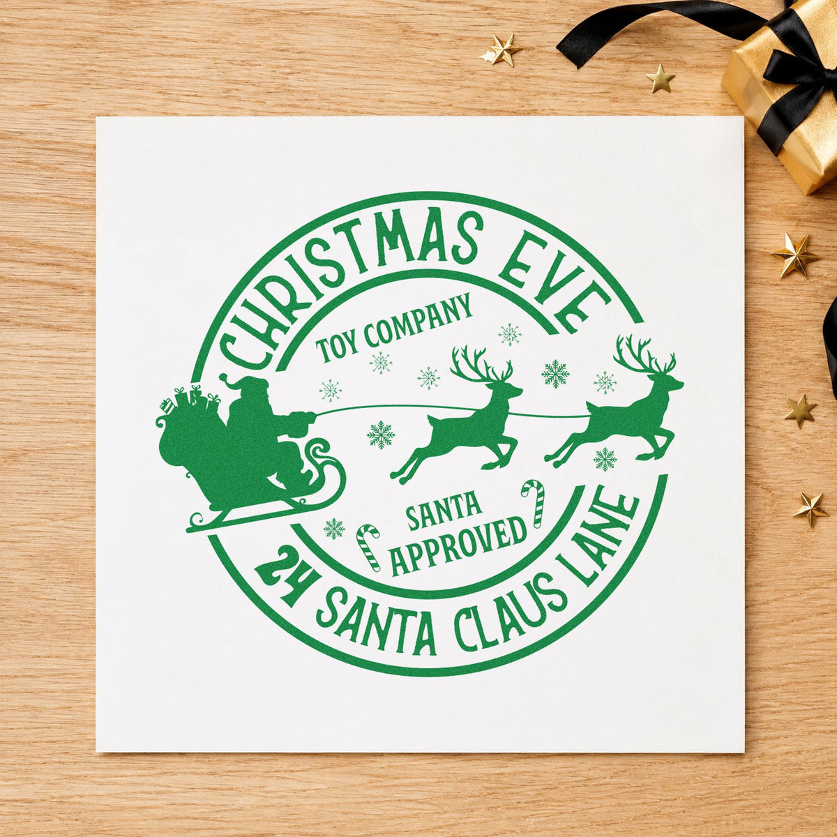 Christmas Eve Toy Company craft stamp imprinted in green ink on paper, a design suited to framed workshop door.