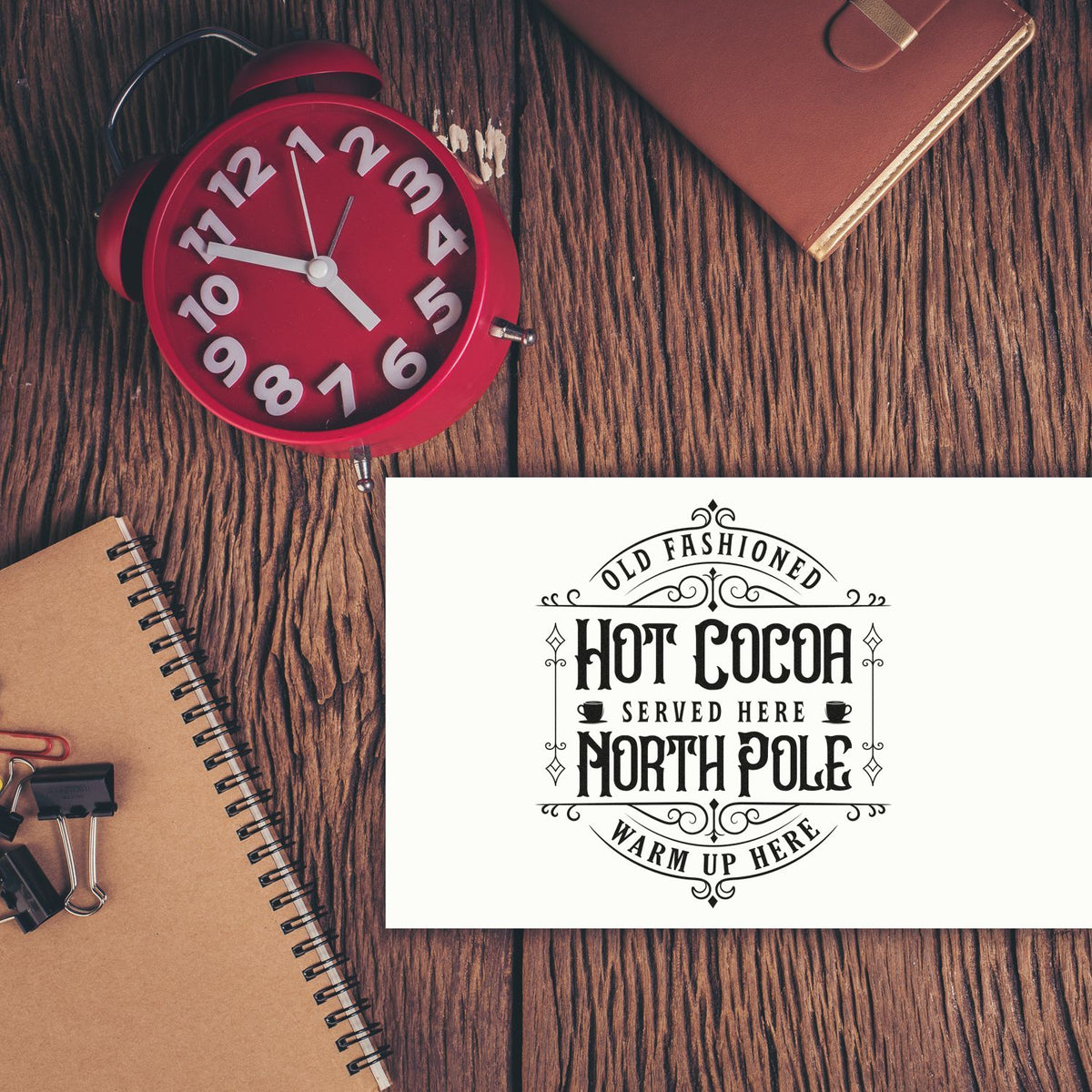 Old Fashioned North Pole Cocoa PSI Pre-Inked Stamp imprint stamped in black ink. An ornate emblem reads "Old fashioned hot cocoa served here North Pole warm up here" with tiny mugs and flourishes.