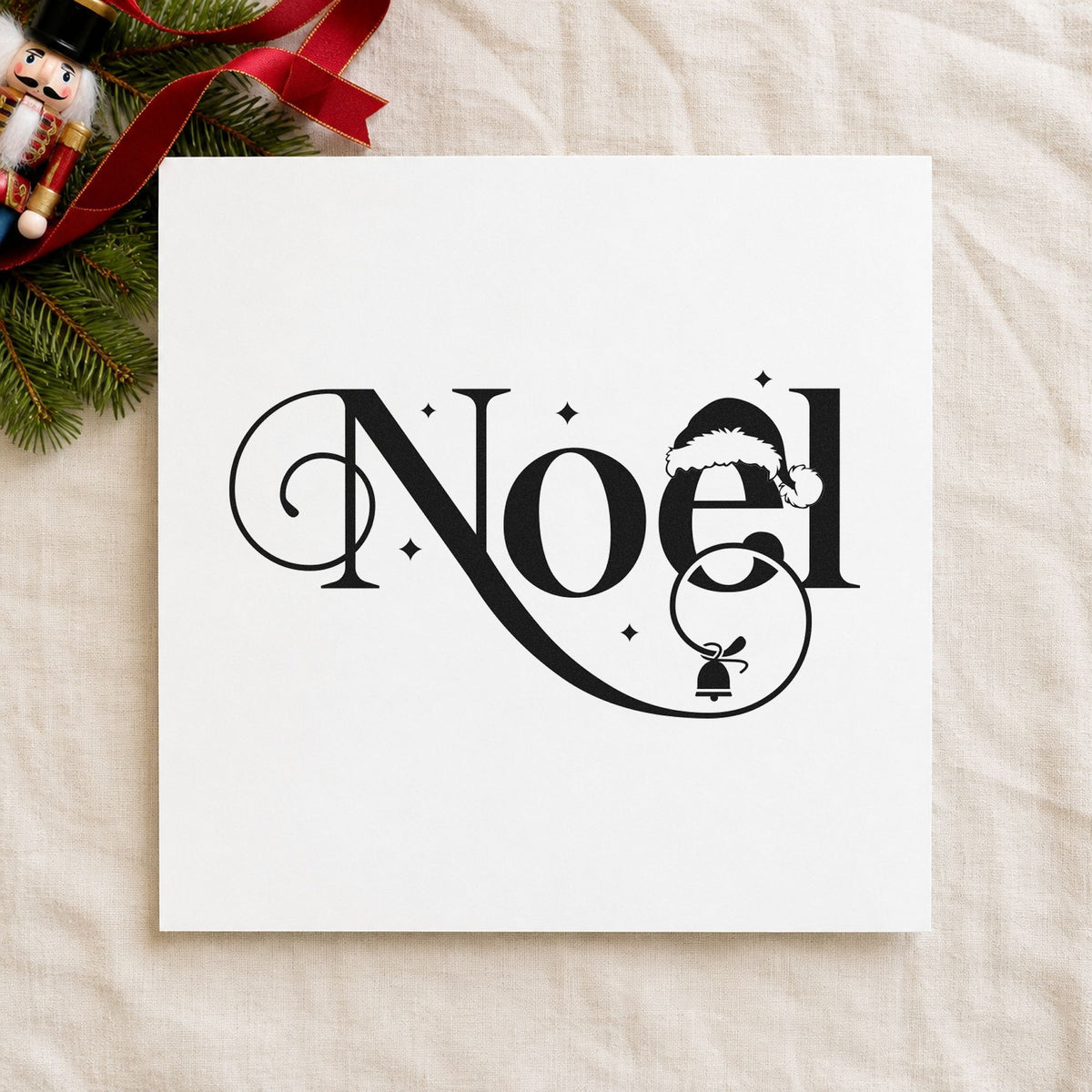 Noel Santa Hat Bell craft stamp imprint in black ink on a handmade project, one idea being bell charm tags.