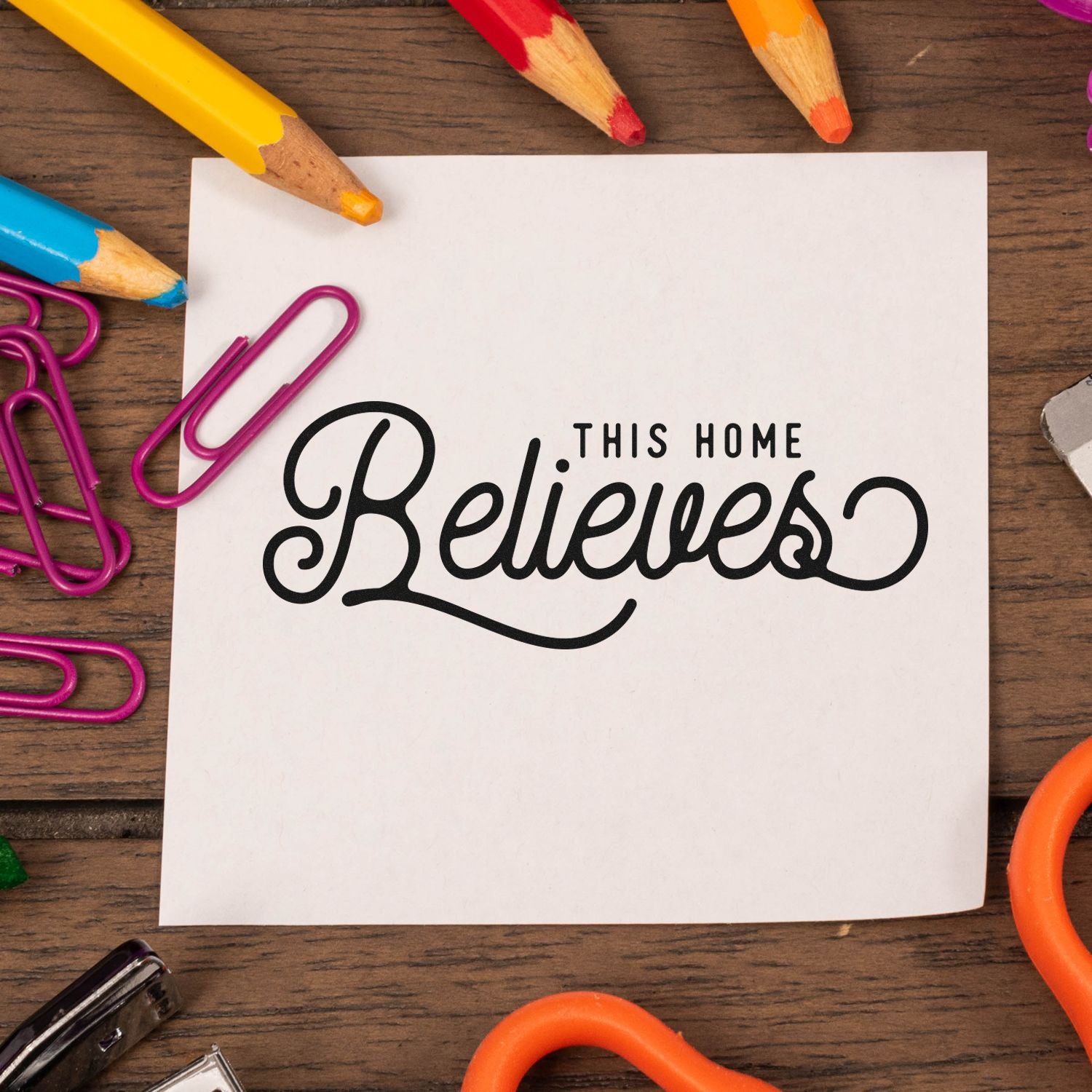 Faith-based rubber stamp reading This Home Believes on paper, ideal for Christian crafts, stationery, and home decor.