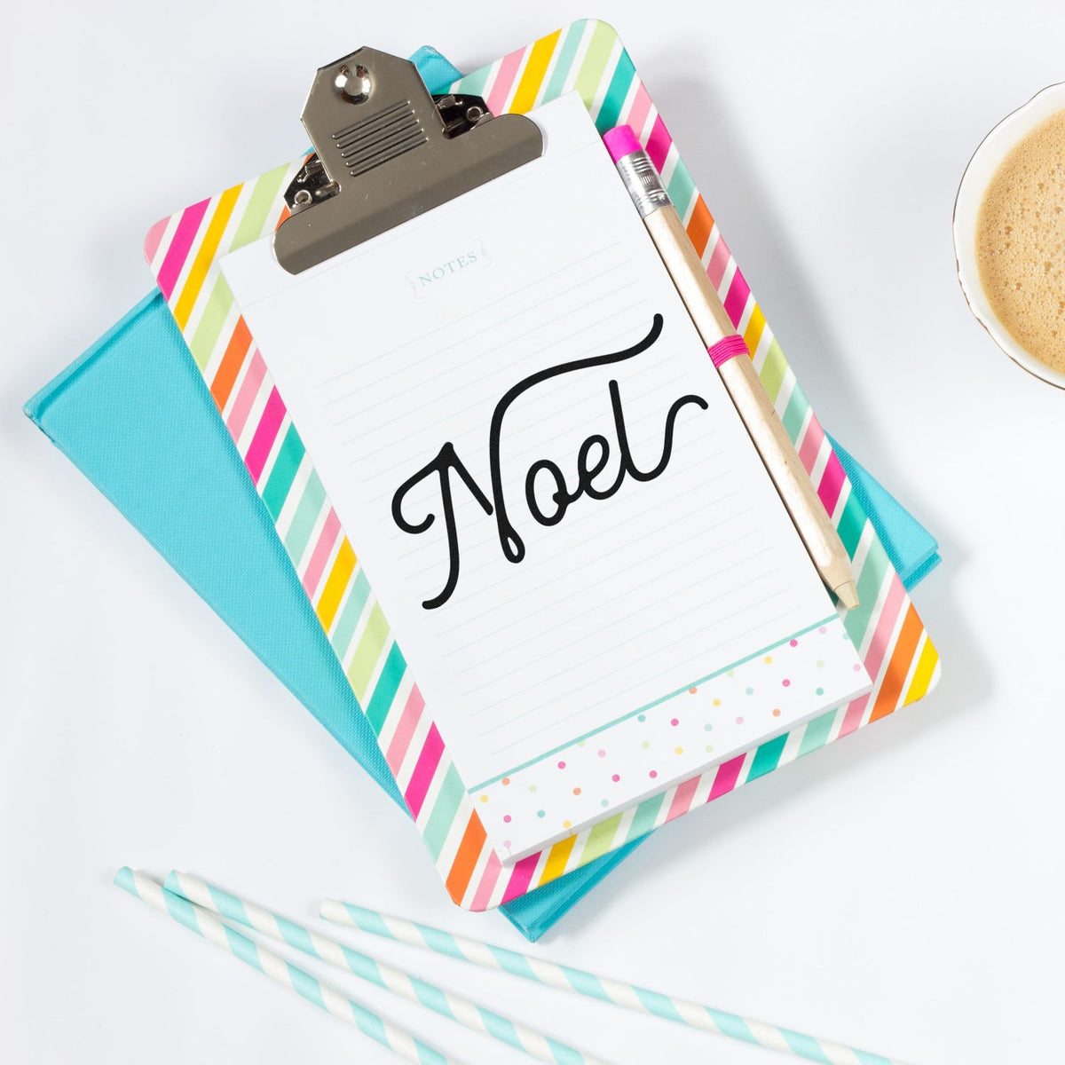 Noel Flowing Script Pre-Inked Stamp – PSI imprint stamped in black ink. The single word "Noel" appears in large flowing script with extended flourishes.