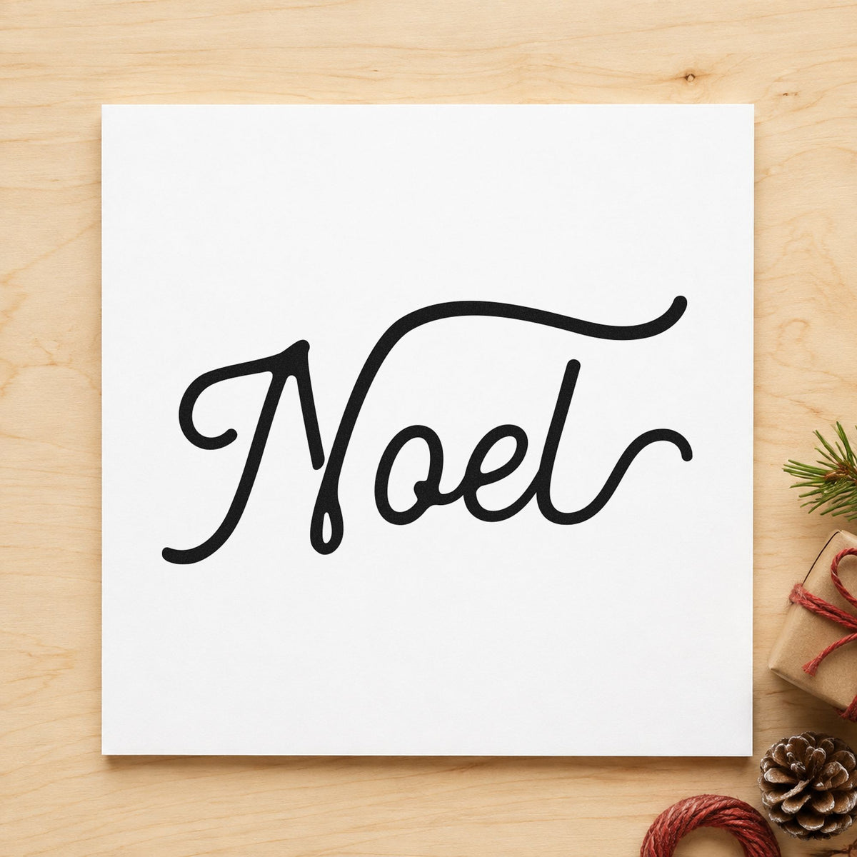 Noel Flowing Script rubber stamp printed in black ink, ready for extended reach cards and similar paper crafts.