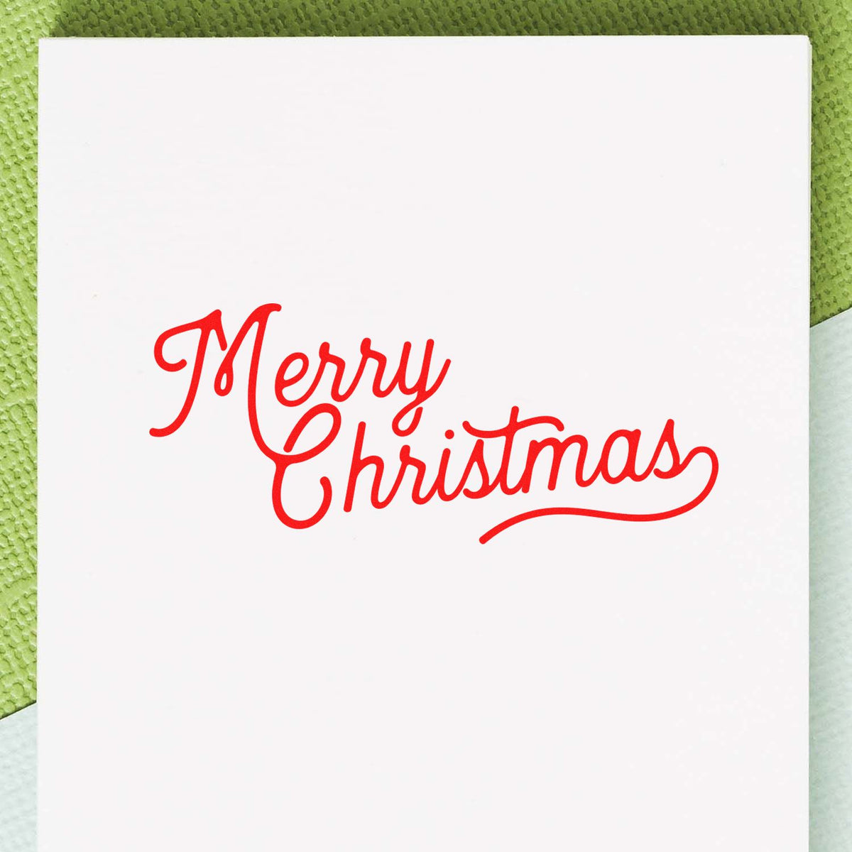 Merry Christmas rubber stamp design in red script on white card for handmade holiday greeting cards