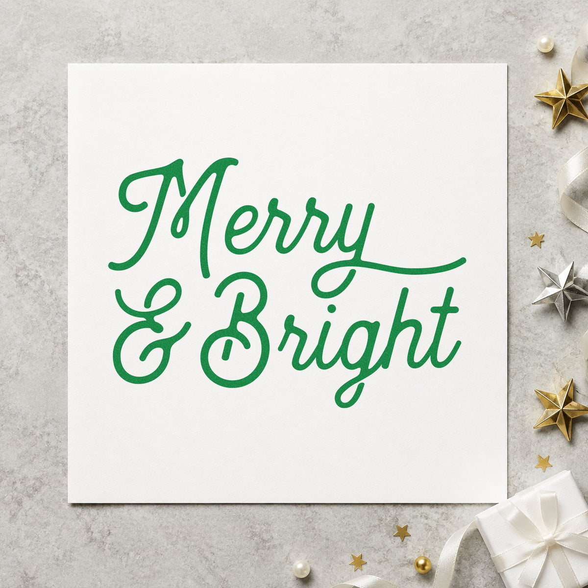 Merry And Bright Script craft stamp imprinted in green ink on paper, a design suited to framed close hang.