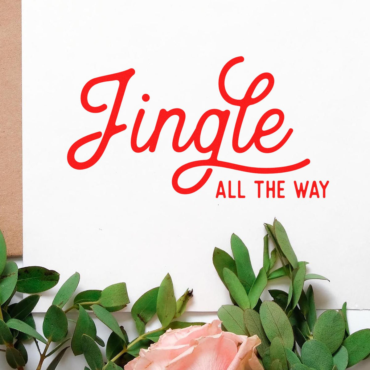 Jingle All The Way Script rubber stamp shown in red ink, stamped for projects such as layered album header.