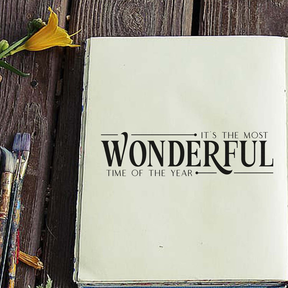 Christmas rubber stamp sentiment reading Its the most wonderful time of the year on a journal page.