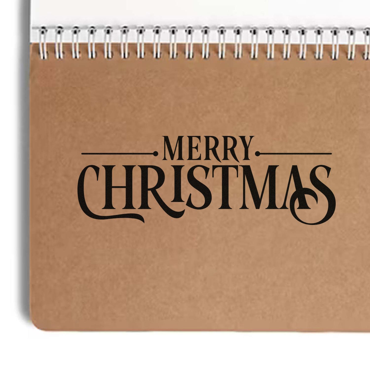Merry Christmas rubber stamp design on kraft notebook cover for holiday cards, scrapbooking, and festive gift packaging.