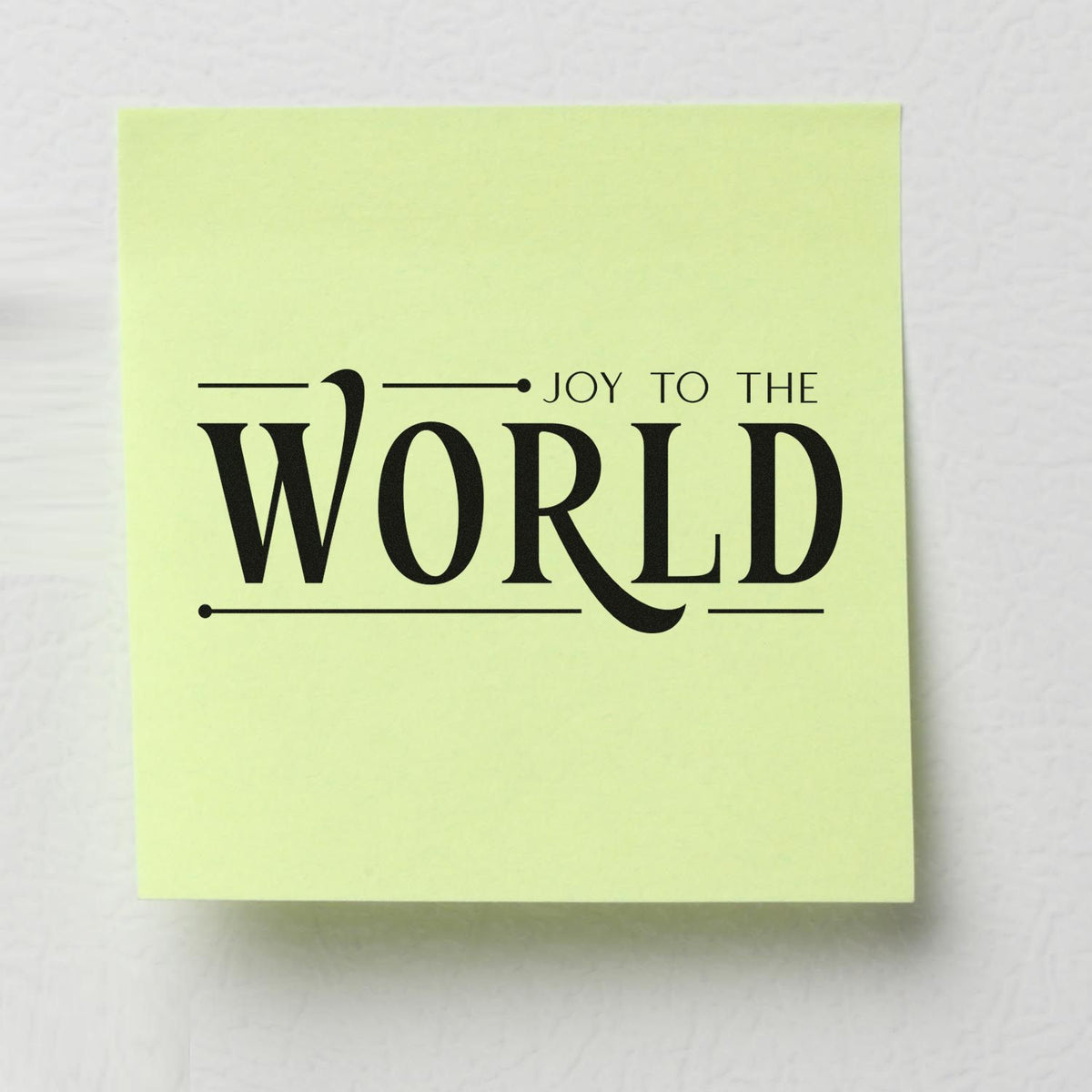 Joy to the World rubber stamp design on light green paper, festive Christmas typography for holiday cards and crafting.