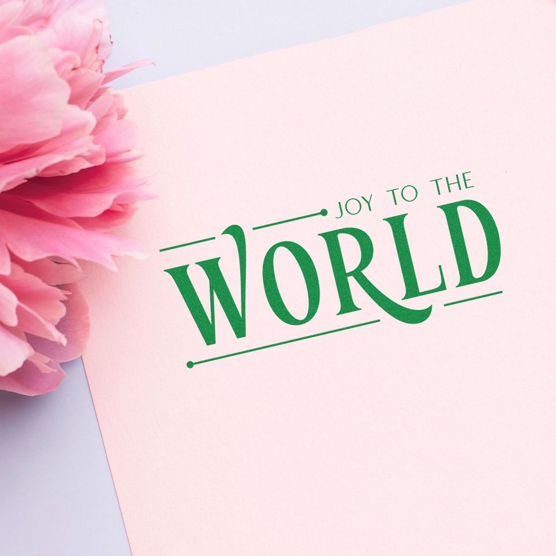 Joy to the World rubber stamp on pink paper with floral accent, perfect for holiday cards and festive handmade greetings.
