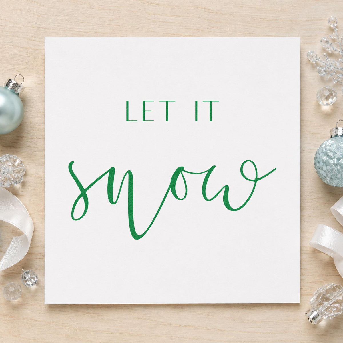 Let It Snow Fine Script craft stamp imprinted in green ink on paper, a design suited to framed spa entry.