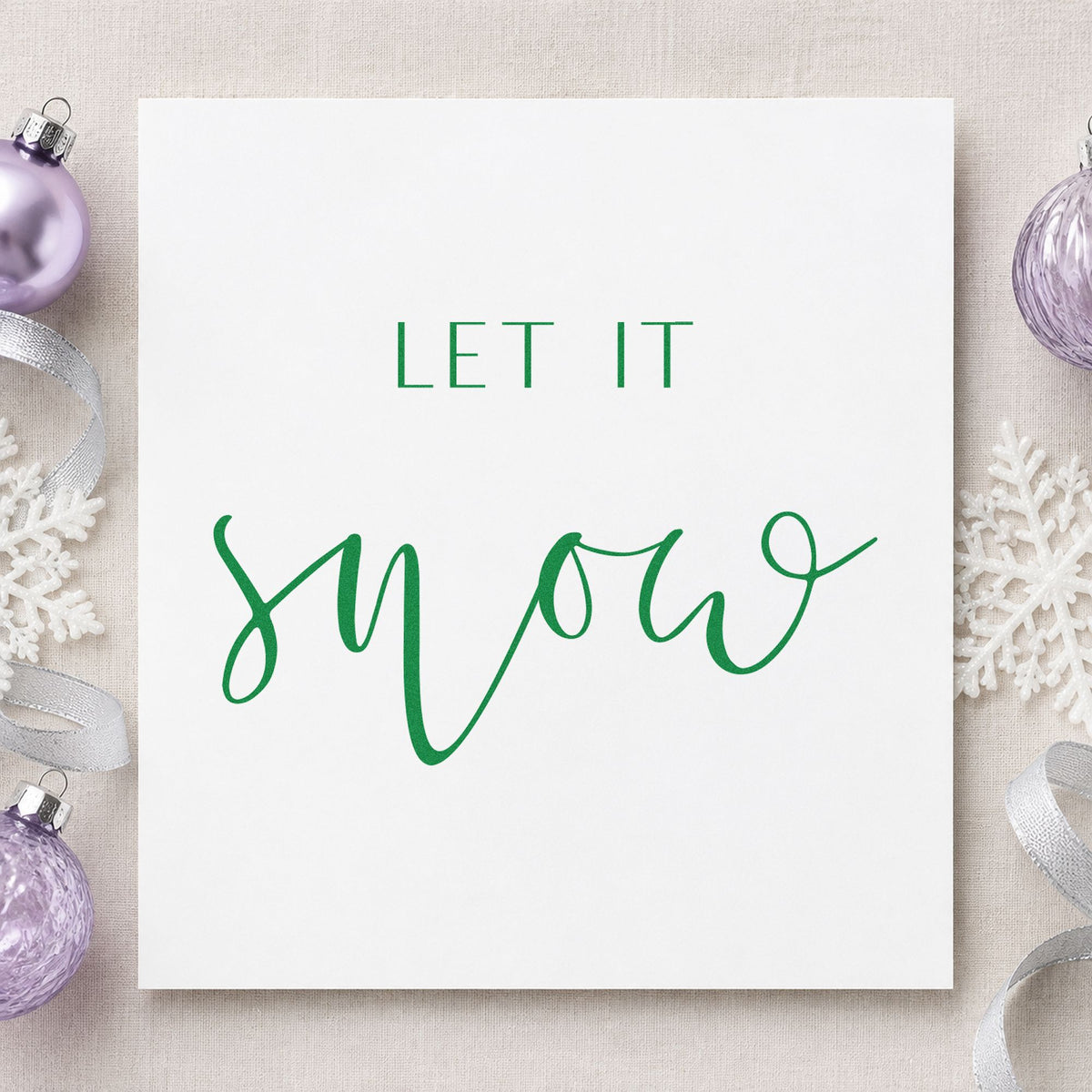 Let It Snow Fine Script craft stamp imprint in green ink on a handmade project, one idea being treatment menu cards.