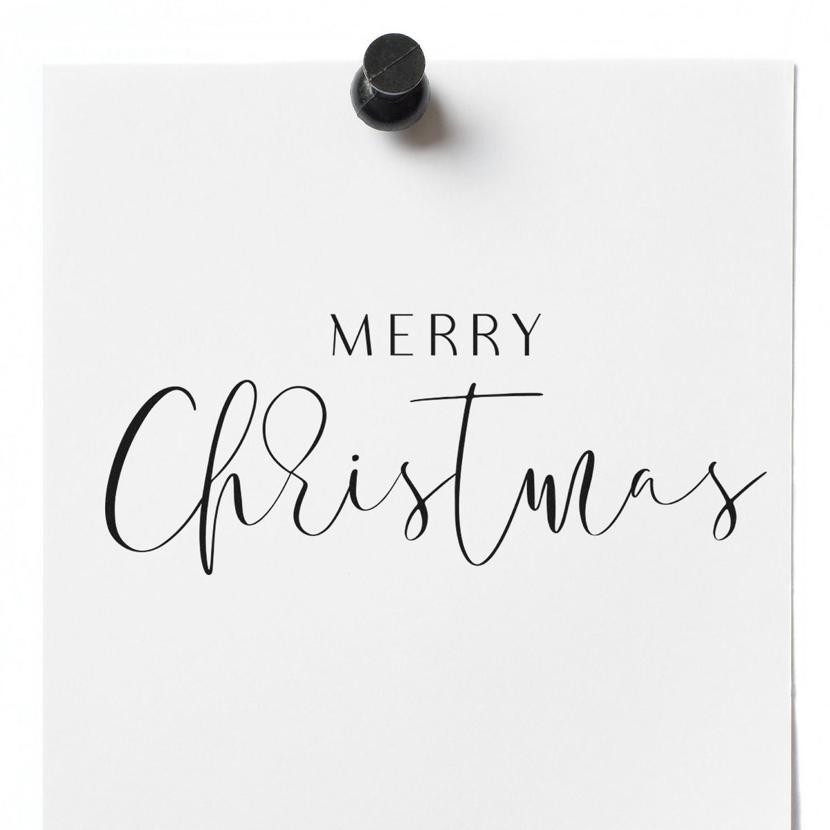 Slim Pre-Inked Merry Christmas Fine Script Stamp imprint stamped in black ink. The greeting "Merry Christmas" combines small spaced capitals with fine flowing script.