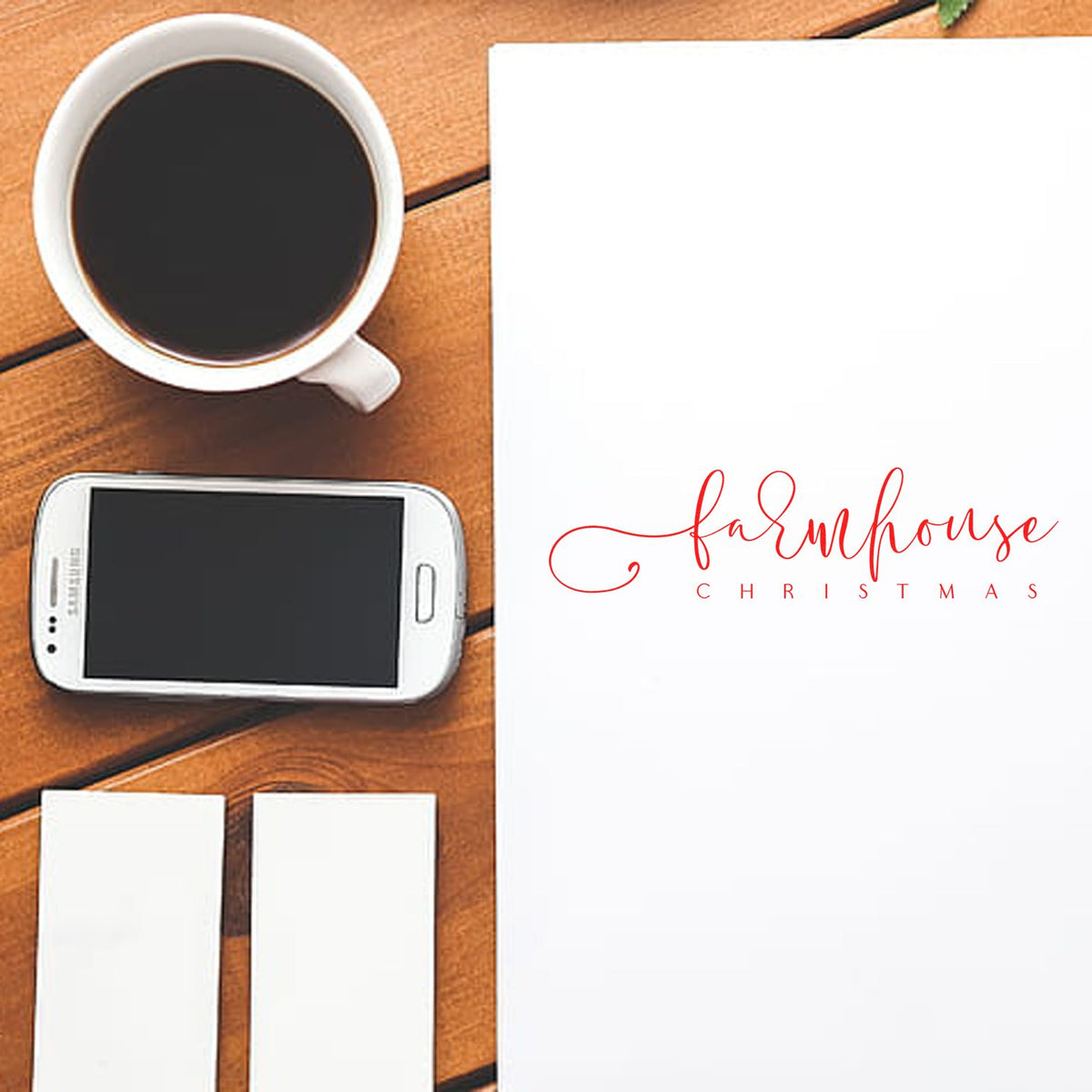 Farmhouse Christmas custom rubber stamp mockup on desk with coffee cup, phone, and blank cards for holiday branding.