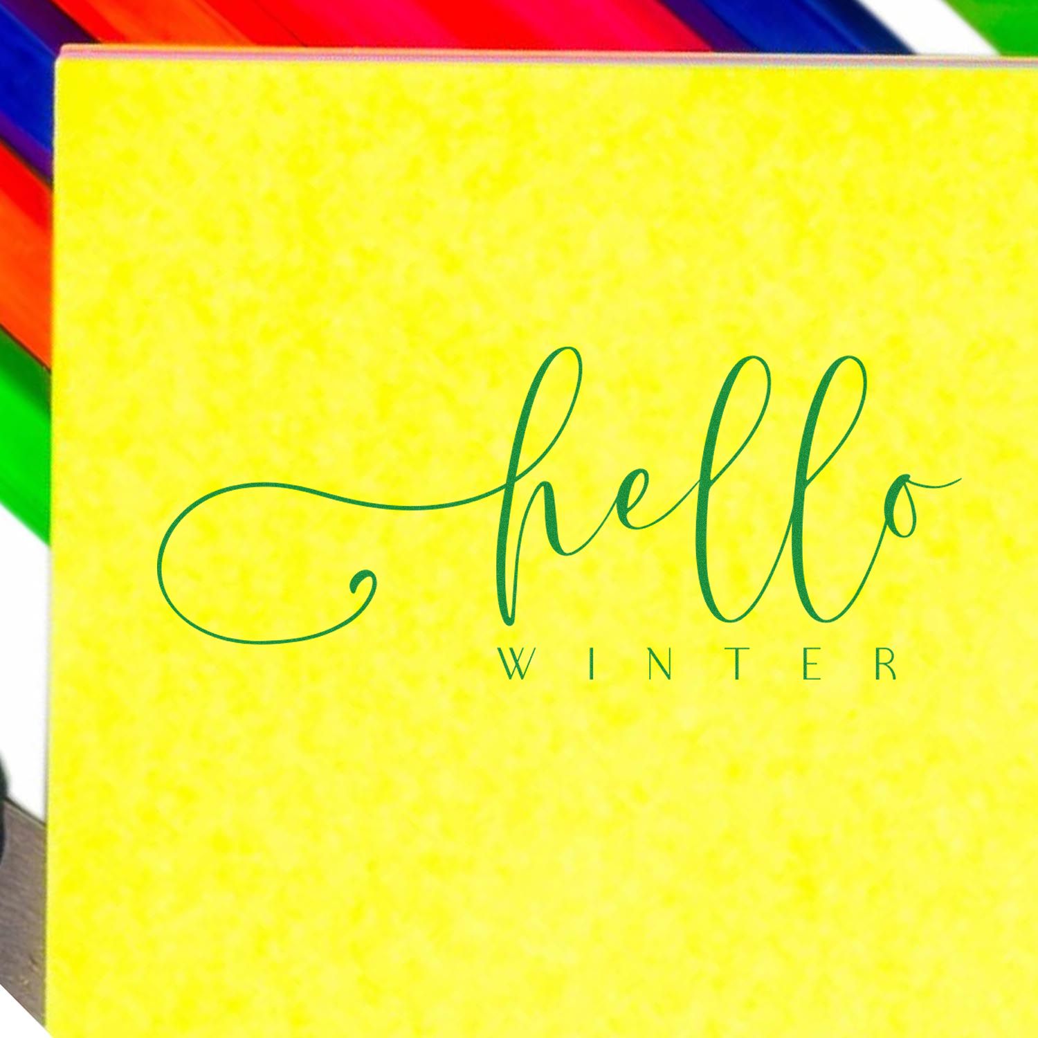Hello Winter rubber stamp design on yellow background with colorful pencils, seasonal greeting stamp for winter crafts