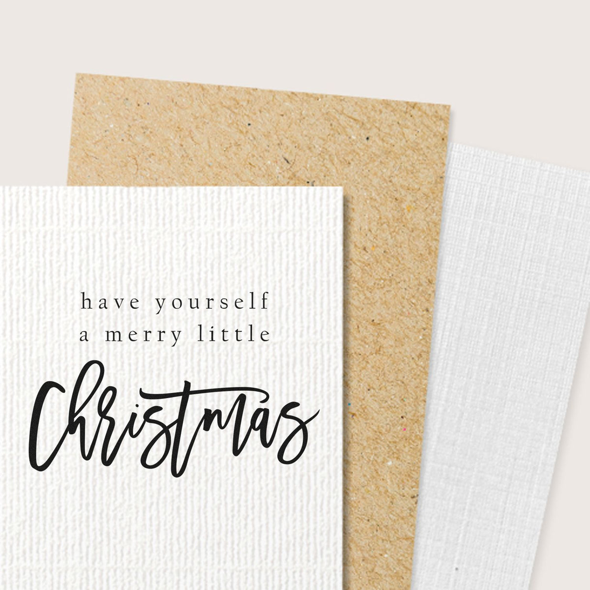 Merry Little Christmas rubber stamp design on textured cardstock for handmade holiday cards and festive paper crafting.