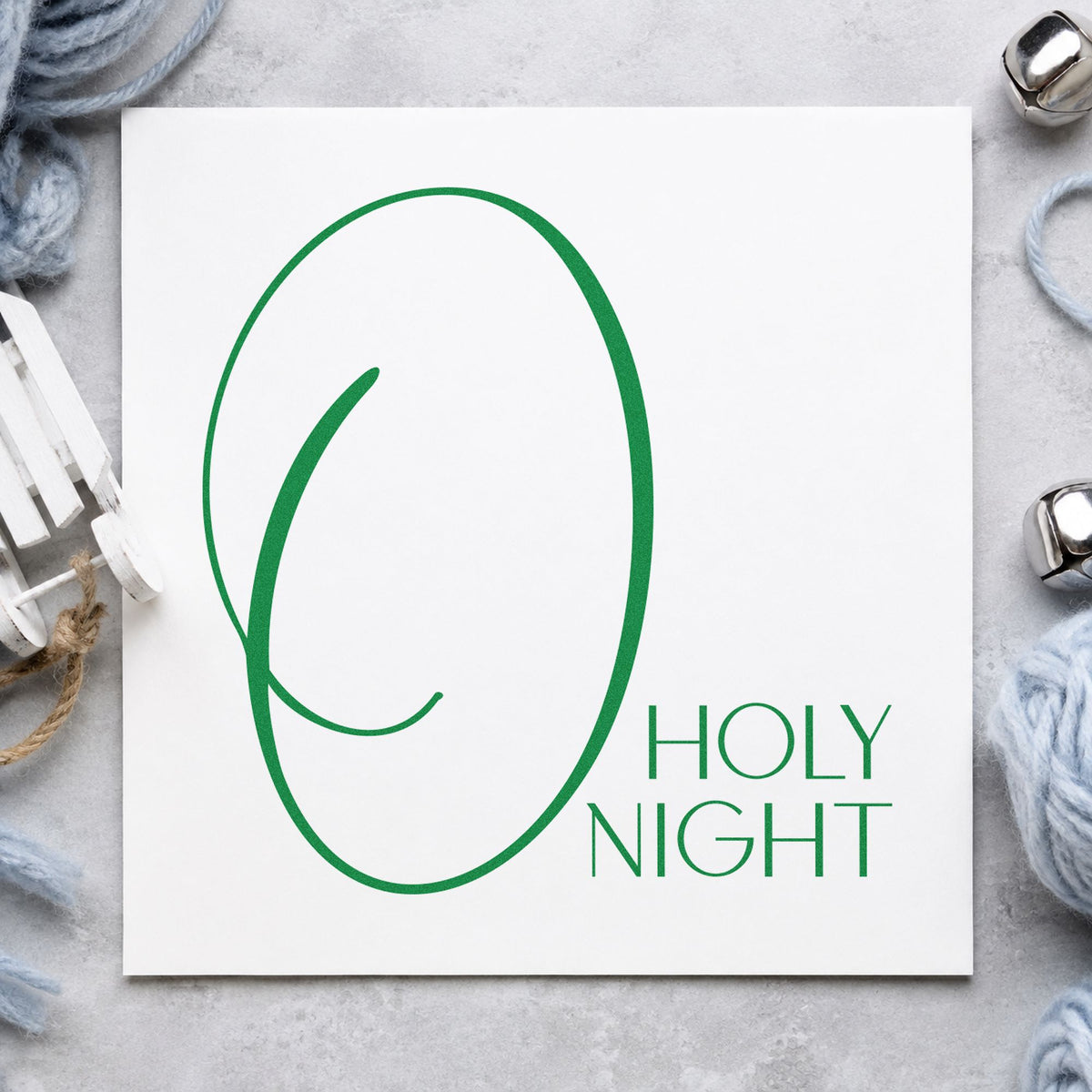 O Holy Night Oversized O craft stamp imprint in green ink on a handmade project, one idea being place setting slips.