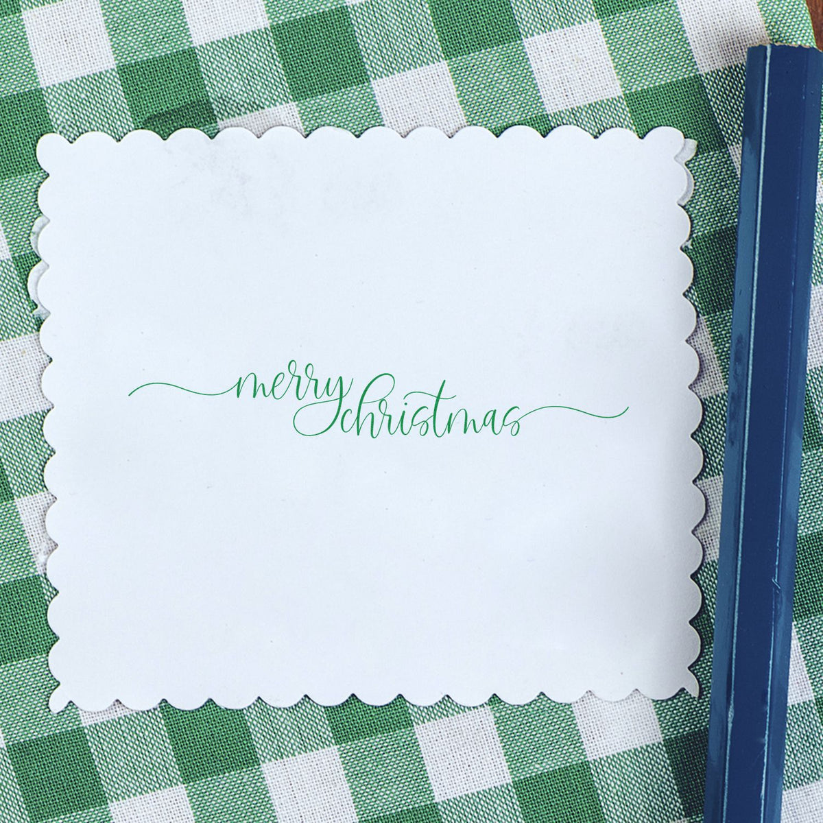 Merry Christmas rubber stamp impression on scalloped card, ideal for festive holiday card making and DIY paper crafts.