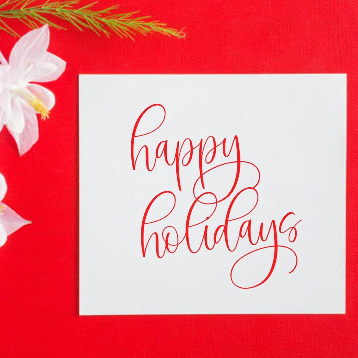 Happy holidays script rubber stamp design on white card with red background, ideal for festive holiday greeting cards.