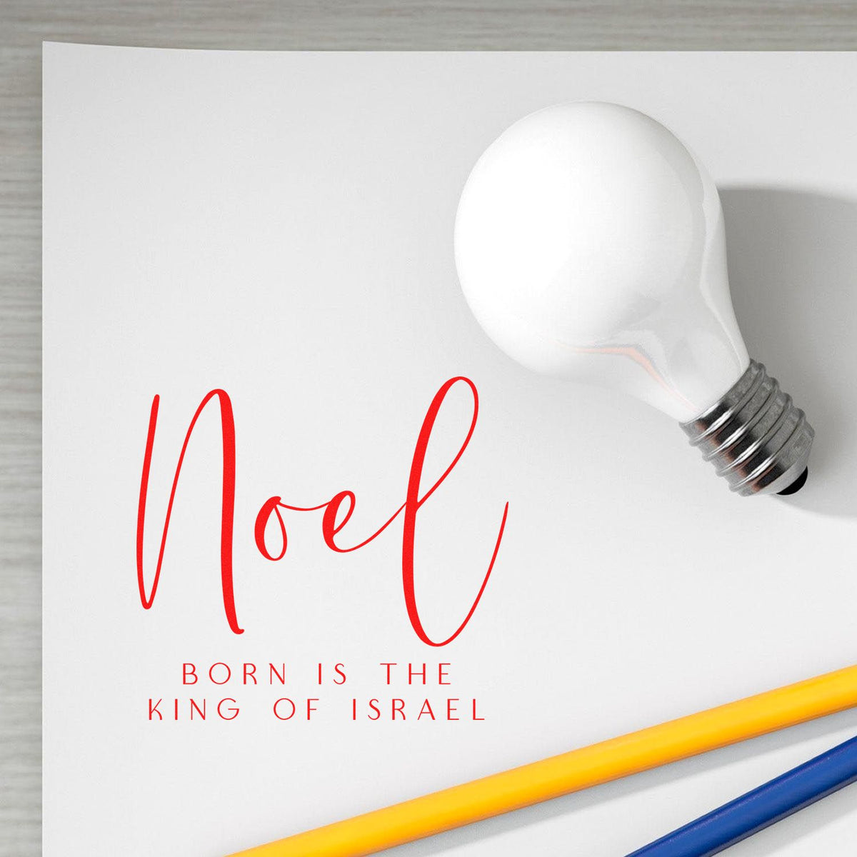 Noel Christmas rubber stamp design with light bulb graphic and Born Is the King of Israel holiday message