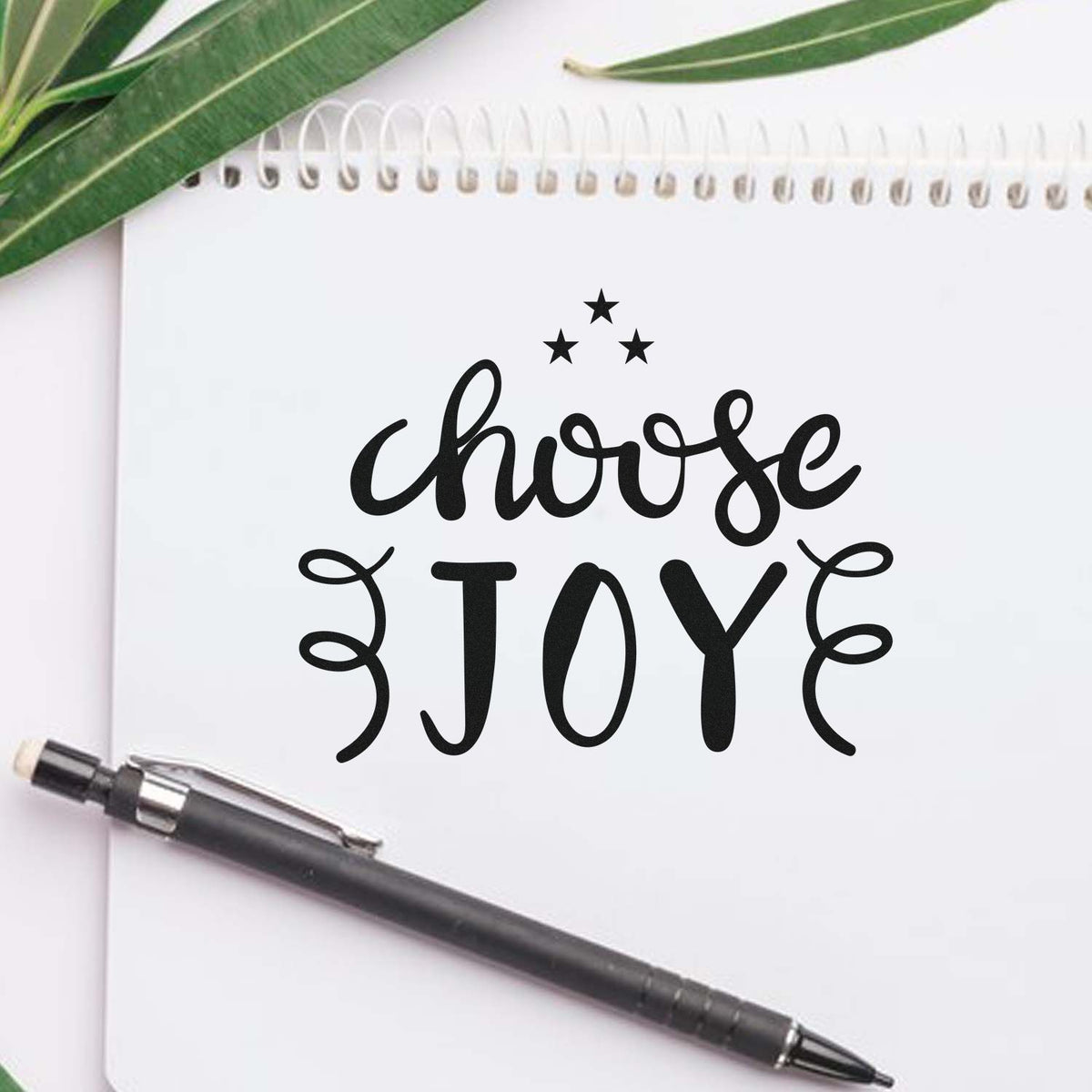 Choose Joy rubber stamp design on notebook, perfect for inspirational crafts, journaling, and handmade cards.