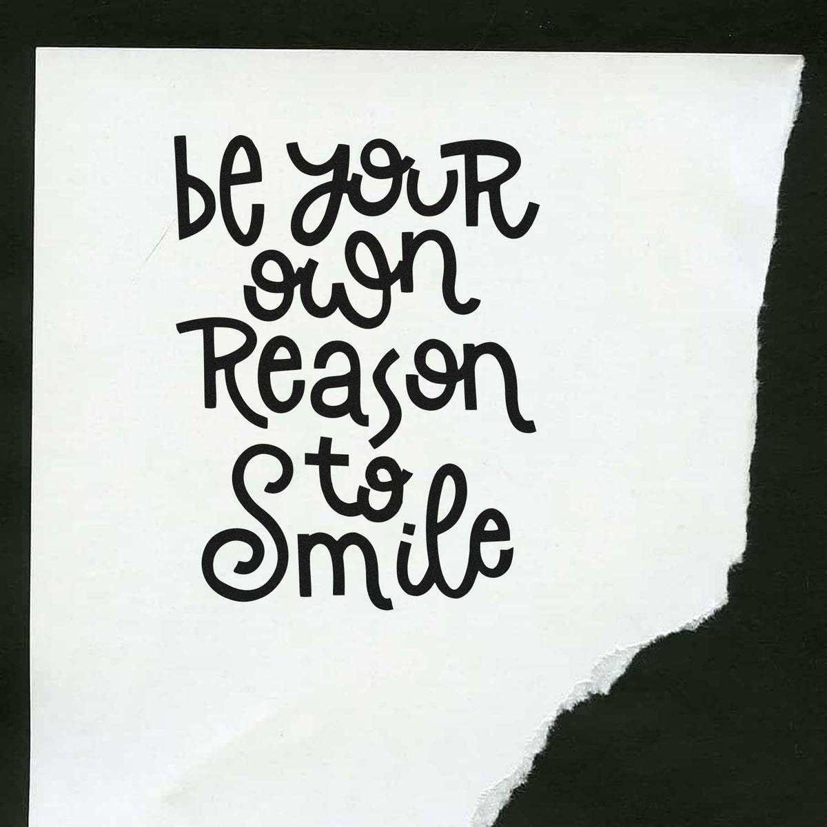 Motivational rubber stamp design with hand-lettered quote be your own reason to smile on torn white paper.