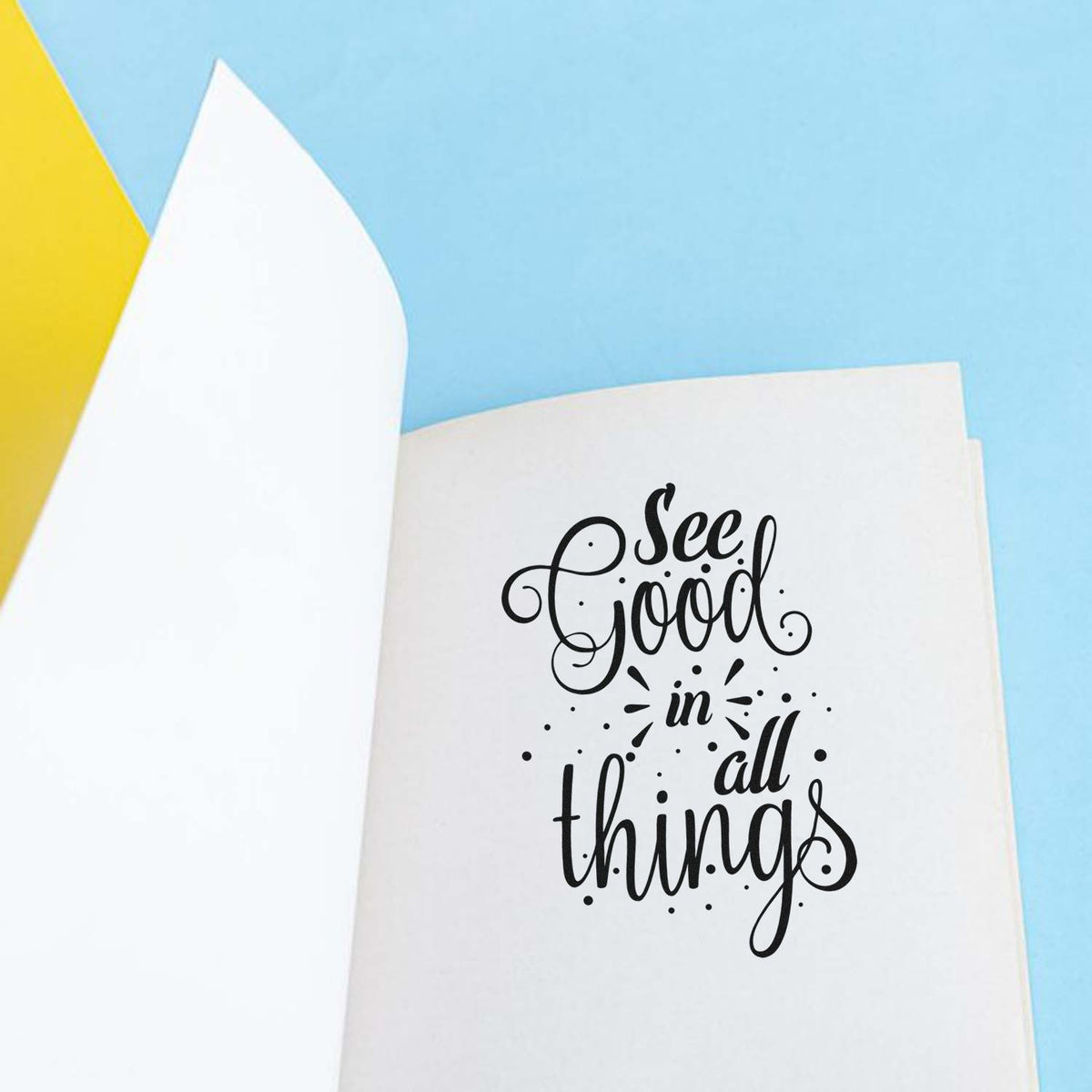 Rubber stamp impression reading See Good in All Things on a journal page, ideal for inspirational crafting and stationery.