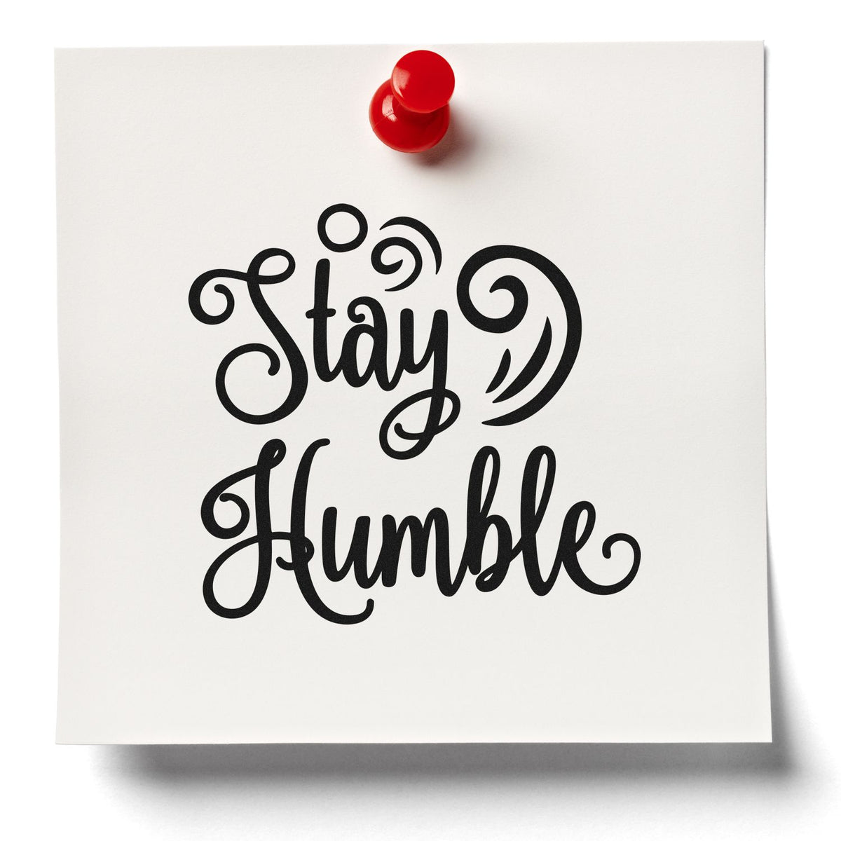 Stay Humble calligraphy rubber stamp design preview on white paper with red pushpin.