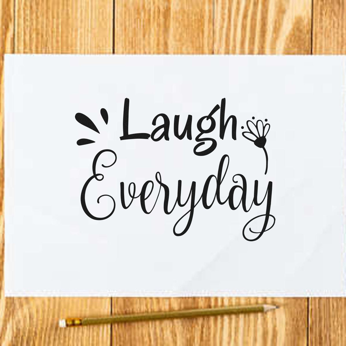Custom rubber stamp design reading Laugh Everyday in hand-lettered script on paper, ideal for DIY crafts and stationery.