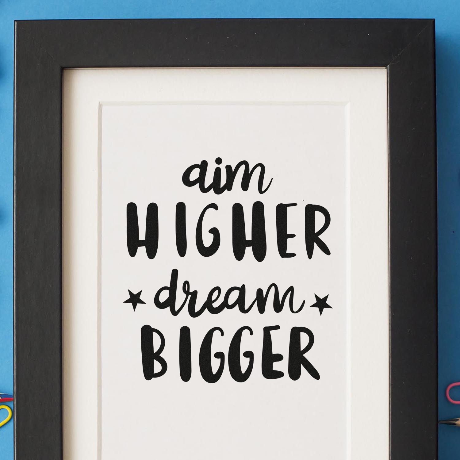 Inspirational rubber stamp design with phrase aim higher dream bigger for custom crafting, stationery, and DIY projects.