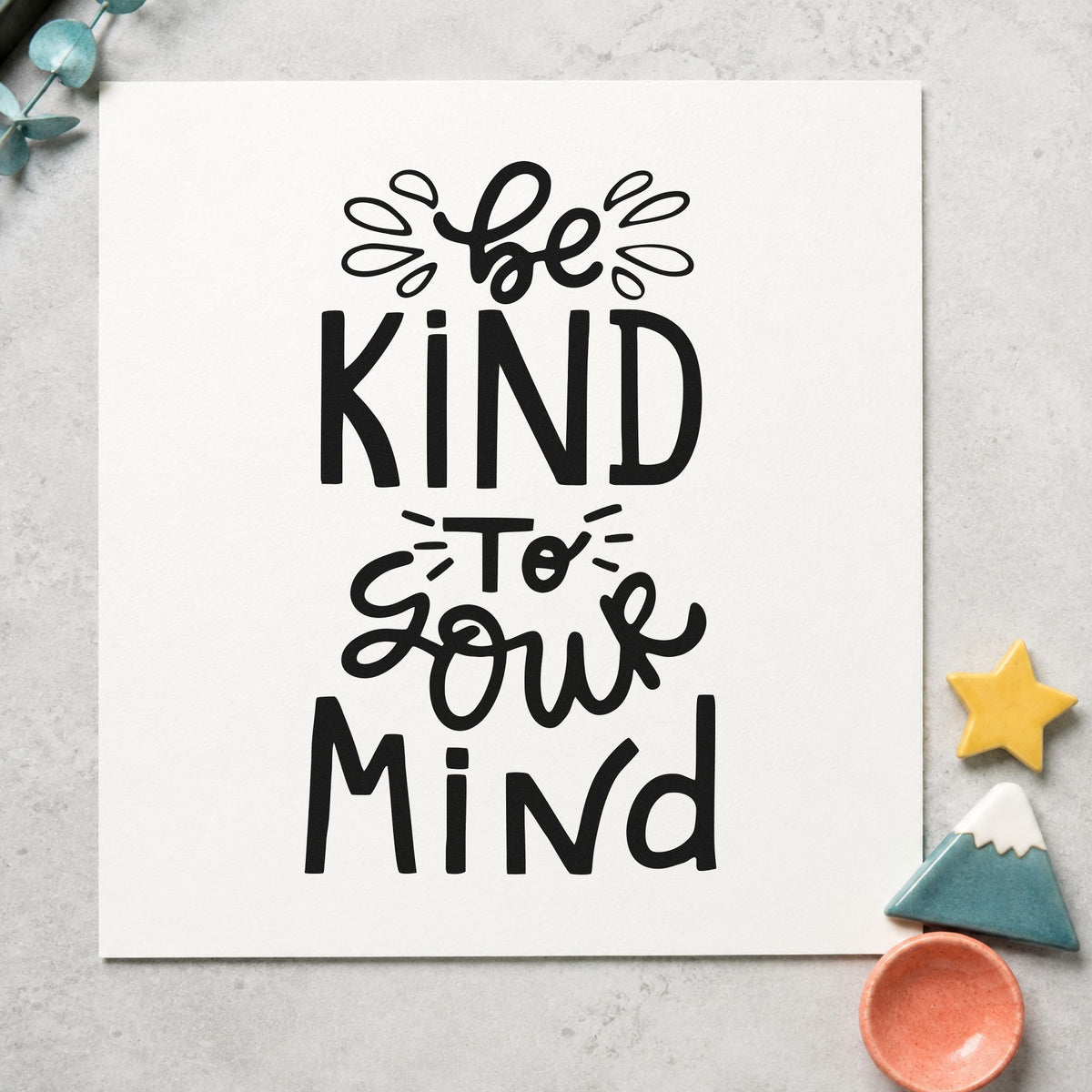 Be Kind To Your Mind craft stamp imprint in black ink on a handmade project, one idea being tea blend gift tags.
