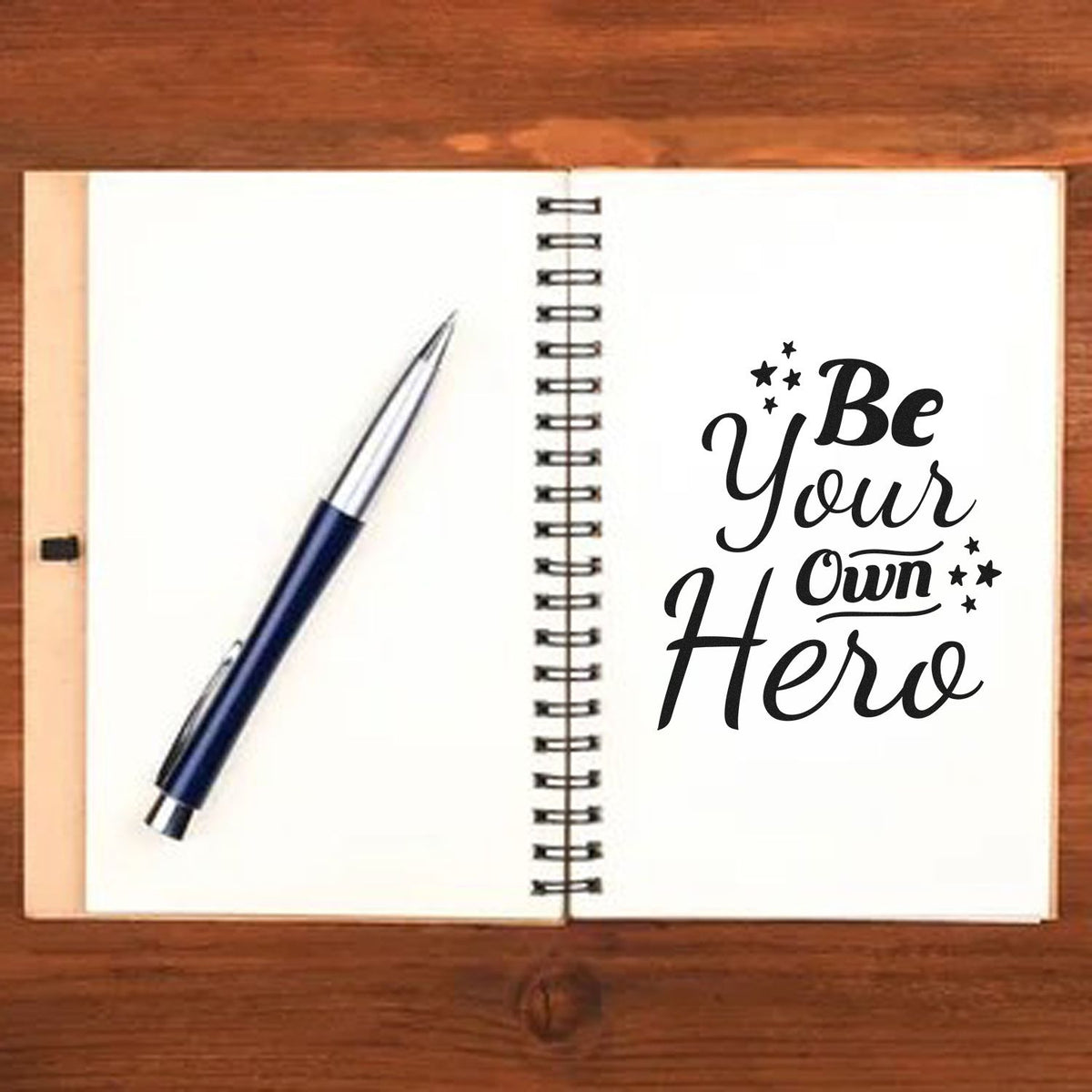 Be Your Own Hero rubber stamp mockup on an open notebook, ideal for inspirational custom stationery and craft projects.