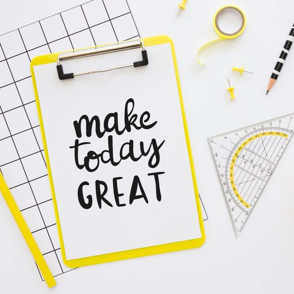 Inspirational custom rubber stamp design reading make today GREAT on a clipboard with stationery and drafting tools.