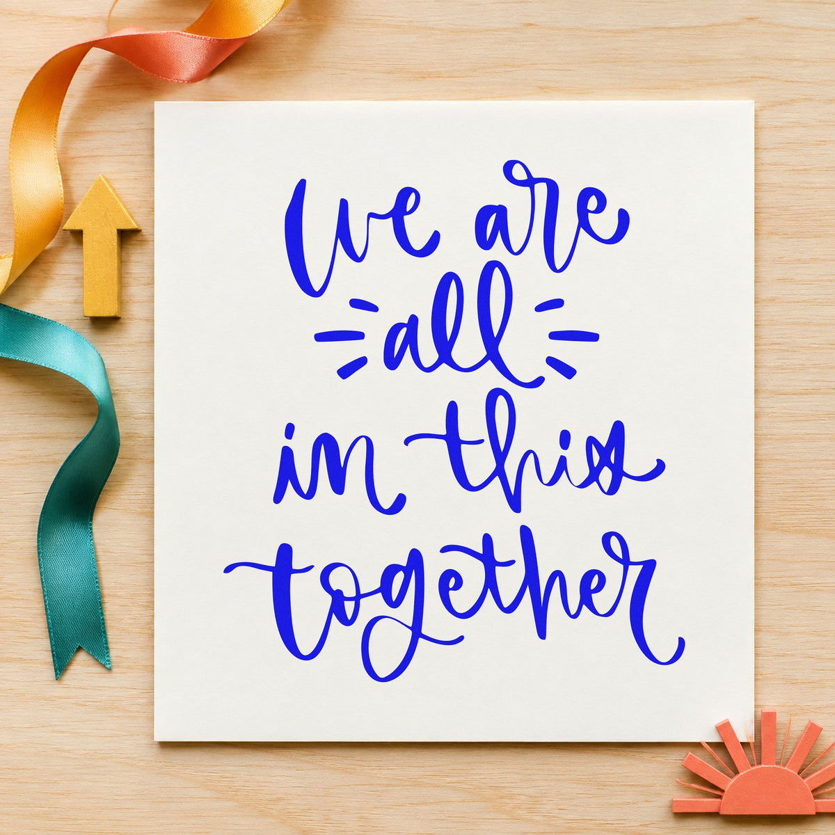We Are All In Together craft stamp in blue ink on cardstock, an easy option for bunting panel printing.